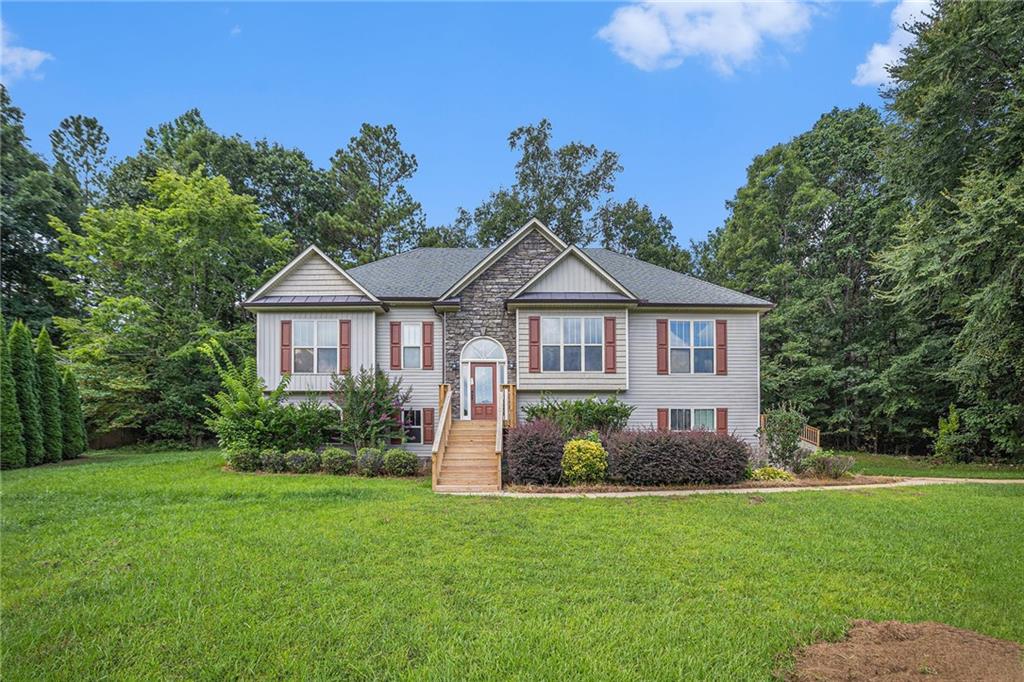 Located in the highly sought-after North Paulding school district, this spacious 3-bedroom, 3-bath home offers a versatile layout perfect for today’s lifestyle. The split-bedroom floor plan provides added privacy, while the large family room features soaring ceilings and a cozy fireplace, ideal for relaxing or entertaining. The open-concept dining room flows seamlessly into the eat-in kitchen, which includes a pantry and solid surface countertops. The oversized primary suite boasts two walk-in closets, a dual vanity, separate shower, and a soaking tub for ultimate comfort. The finished basement offers incredible flexibility, with two additional rooms and a full bath - perfect for a teen or in-law suite, home office, or media space. Enjoy outdoor living on the back deck and take advantage of the 3-car garage with ample storage.