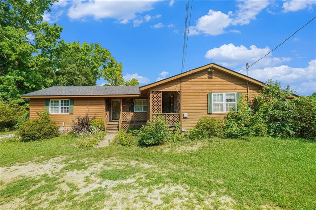 Classic country living at it's finest! Welcome to this charming Ranch-style Farmhouse on Nearly One Acre with Pool, huge garage, and NO HOA! The split bedroom floor plan offers privacy with a spacious primary suite, featuring a tile soaking tub, walk-in closet, vanity, and tile flooring. The inviting living space is open and cozy with stone fireplace. The country-style kitchen boasts a breakfast bar and eat in dining space that overlooks the serene backyard. A versatile bonus room provides the perfect flex space for a home office, playroom, or optional fourth bedroom. Relax and unwind on the expansive front, side, or rear porches--or enjoy sunny afternoons in the above ground pool! This property also includes a large detached garage with an extra large roll-up door--ideal for boats, RV, large trucks, and the like. A second outbuilding, complete with electric, heating and cooling, and a lean-to, adds even more flexibility for hobby space or additional work space. Conveniently located and full of charm, this is the ultimate farmhouse retreat! Schedule your private showing today! Roof is NEW in 2025!