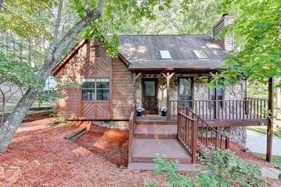 Welcome home to this lovingly maintained home by the same owners for the past 28 years! This home is truly move in ready - it's been freshly painted inside since the sellers moved out; the carpets have been cleaned; fresh mulch spread in the front and backyard; HVAC last serviced in July and thermostat replaced. The windows were replaced, and the deck was extended and partially covered in 2011; the kitchen and primary bathroom remodeled in 2015; upstairs carpet replaced in 2021 and primary bedroom carpet replaced in 2023; exterior of the house was repainted in 2023 and new garage doors installed in 2023 as well. This home offers the opportunity to own in award-winning Lassiter High School district, with a Roswell address (but lower Cobb County taxes), with no HOA. The stone accent on the exterior is the same stone as the floor-to-ceiling fireplace in the living room and is absolutely stunning in person. You'll also love the vaulted ceilings in the living room (with the incredible stone fireplace) and the primary bedroom which really make the rooms feel incredibly open. The sellers will tell you that they loved the home because it feels like a cabin in the woods, but right in the middle of Roswell. They loved the peace of the front porch, as well as the huge rear deck and the private, wooded view. One of their favorite spots was the swing under the deck and they've left the swing for the owners to fall in love with as well.