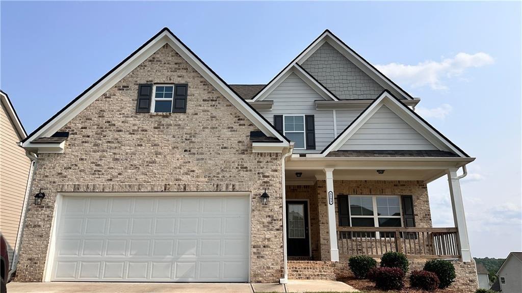 Welcome to this move-in ready 5-bedroom, 3-bathroom home in the desirable Overlook at Hamilton Mill community! Built in 2023, this spacious residence offers a modern open layout with one bedroom and full bath on the main level—perfect for guests or a home office. The stunning kitchen features stained cabinets, a gas cooktop, dishwasher, disposal, and opens to the breakfast area and oversized family room. Upstairs, the generous master suite is accompanied by three additional bedrooms, another full bath, and a convenient laundry room. Enjoy hardwood floors, crown molding, and a full unfinished daylight basement offering ample storage or future living space. Community amenities include a swimming pool, park, and proximity to shopping, trails, and top-rated schools like Mill Creek High. Located just minutes from I-85, this home combines comfort, space, and convenience in a beautiful setting.