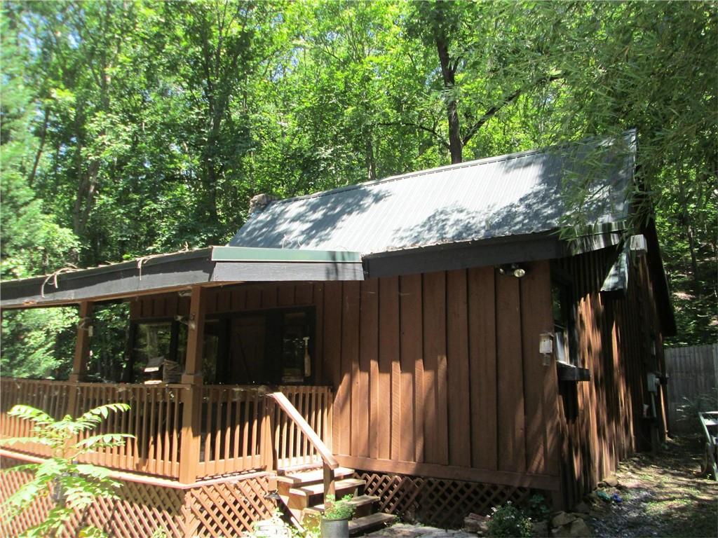 WOW!!! Describes this Lake/Mountain Retreat, 2 bedrooms, 2 bath, Hardwood and Tile Floors thru out, granite counter tops, field stone fireplace, central HVAC, Tongue and groove interior walls, Sun room, Sleeper Porch, Out door fire pit, stream, metal life time roof, this is truly a wilderness retreat and a stone throw from the lake. There is an additional home at 402 Sun Mountain Drive which is also available, see separate listing for its details. All appliances remain including W/D