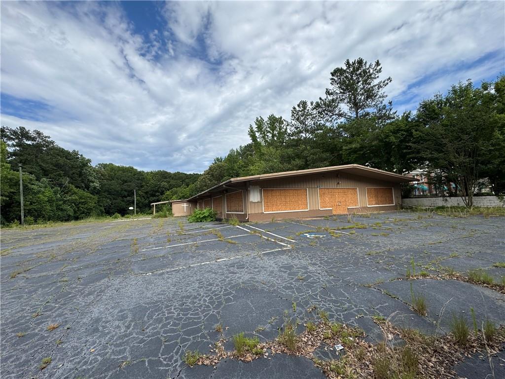 Prime 2.09 acres of land in the historic Ben Hill neighborhood. Currently has an 8040 SF building that was previously used as a church with ample (75+) parking. Perimeter is fully fenced with secure access gate. Marquis sign on high rise pole on premises. Structure may be repurposed or torn down for redevelopment. Conveniently located just around the corner from Campbellton Rd SW and Fairburn Rd SW with 205 ft of frontage on Fairburn Rd and approximately 445 ft deep with predominantly level topography. The Williams Walker Recreation Center, Ben Hill Park, Retail Stores, Dentistry, and Atlanta Fire Dept are in close proximity. Easy access to I-285, up and coming community neighborhoods, new housing developments, and commercial developments. Zoning is C1 commercial with specific MRC-2-C zoning that allows for mixed use residential / commercial development with up to 40 units per acre. Land and structure are FOR SALE only and SOLD AS-IS. Owner has not occupied this space.