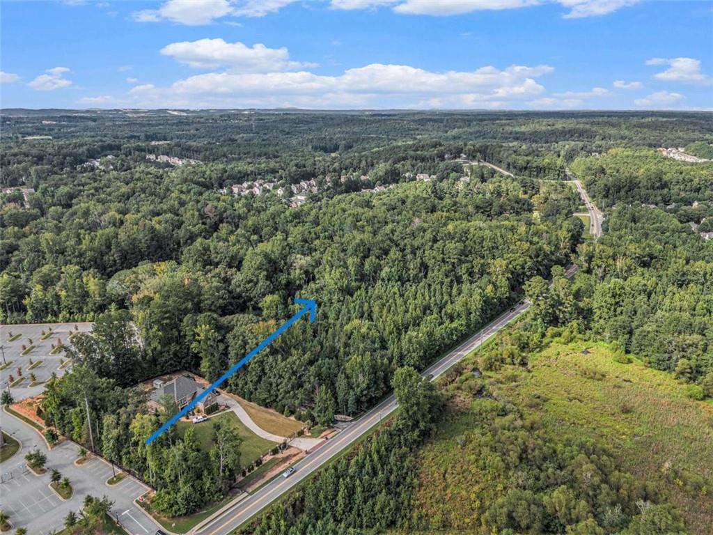 3.8-acre wooded lot with versatile potential. Zoned Sub-C (Suburban Commercial), the property allows for residential, office, or select commercial uses. An older home sits on the property (do not enter), offering the option to rebuild or redevelop. Minutes from Wolf Creek Country Club, Camp Creek Marketplace, major highways, Downtown Atlanta, and Hartsfield-Jackson Airport. Whether you're envisioning a custom estate, multiple home sites, a professional office, or a community-serving institution, this property provides the canvas. Its Sub-C zoning delivers the kind of flexibility rarely found in today's market.