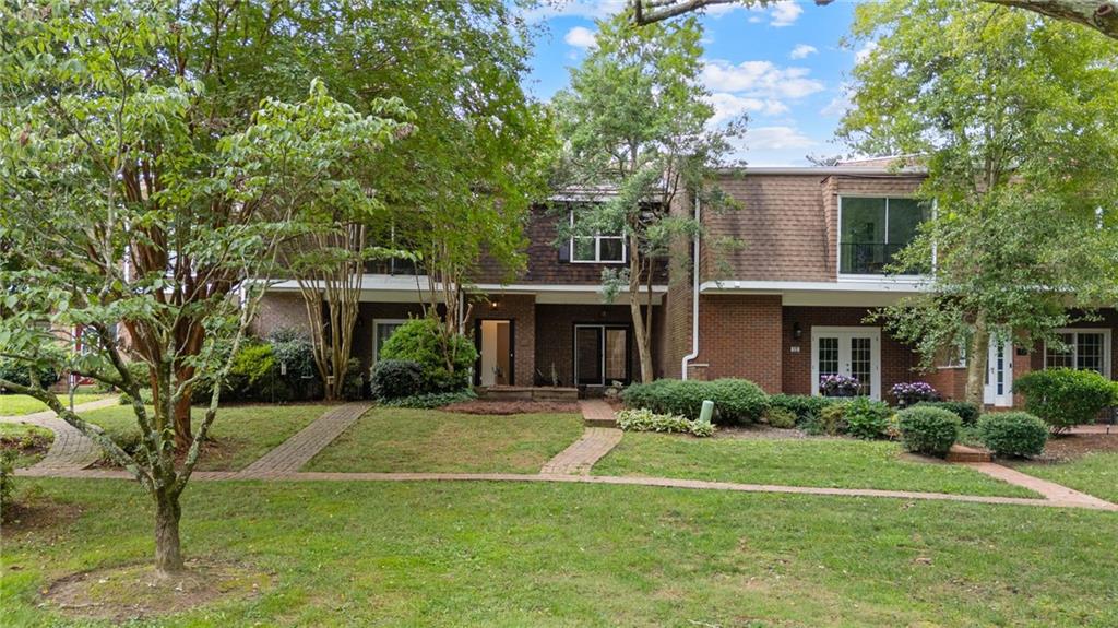 WELCOME HOME! Cutest townhouse ever right off Whitlock 3 minutes to Marietta Square! As you enter the light filled living space you'll notice the French doors to your front patio, a foyer area, and a historic fireplace with new vintage tile! All of downstairs features new wood tile! Kitchen features all new quartz countertops, stainless steel appliances, new cabinets, and island overhaul perfect for breakfast stools overlooking into the dining space! First floor also features a half bathroom perfect for guests, walk in laundry room, two storage closets, mud room area with hooks, and a bonus room perfect for a office/playroom/work out space! As you go upstairs you'll again notice the great light this unit brings in! two greatly sized bedrooms and hallway bathroom with new floor tile! Master suite includes real hardwood floors, walk in closet, and bonus space perfect for an office/reading nook/workout space! Master bathroom has been completely redone with walk in shower, new cabinets, quartz countertops, and new hardware! Two car garage on main level makes carrying in groceries so easy! This unit overlooks the courtyard and green space giving you tons of privacy! Whole house has been updated throughout with new paint, new wood tile flooring on main level and real hardwoods upstairs, new HVAC, new appliances, new cabinets, new bathrooms, new kitchen, new hardware, and exterior has been pressure washed! Coveted Burress Elementary, Marietta Middle, and Marietta High!