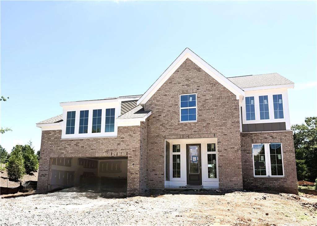 New construction residence featuring a prominent front gable, multiple window placements, and a partial front porch