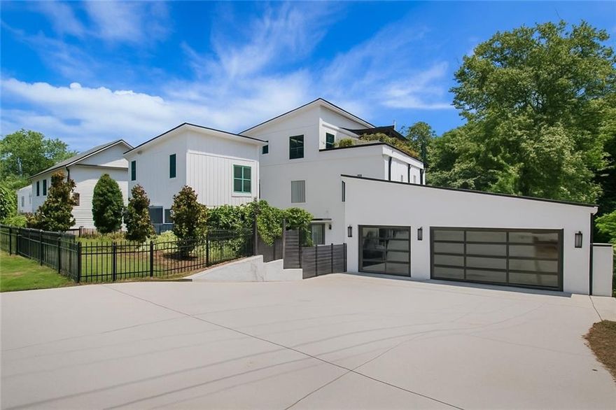 Live in luxury and walk to all that Downtown Woodstock has to offer from this one-of-a-kind, custom built home just off of Main Street. Set on over half an acre, this private courtyard estate features a 4 bed / 4 bath main home with open living spaces, a chef’s kitchen and oversized island, high end appliances, and designer finishes. The primary suite sits on its own level with a private sun deck. The newly built separate pool house includes 1 additional bedroom and 1.5 additional bathrooms with a guest suite, bonus room  and a beautiful kitchenette, ideal for multi-generational living, entertaining or extra space for guests. The heated saltwater pool and spa create a true outdoor living space for year-round enjoyment. Additional features  include a home office on the main (could be a bedroom on main if needed) gym, custom mudroom, and glass garage doors for seamless indoor-outdoor living. This is not a typical in-town property. It’s a unique combination of land, architecture, privacy, and walkability to shops, dining, music, parks and so much more from Downtown Woodstock’s most desirable locations.