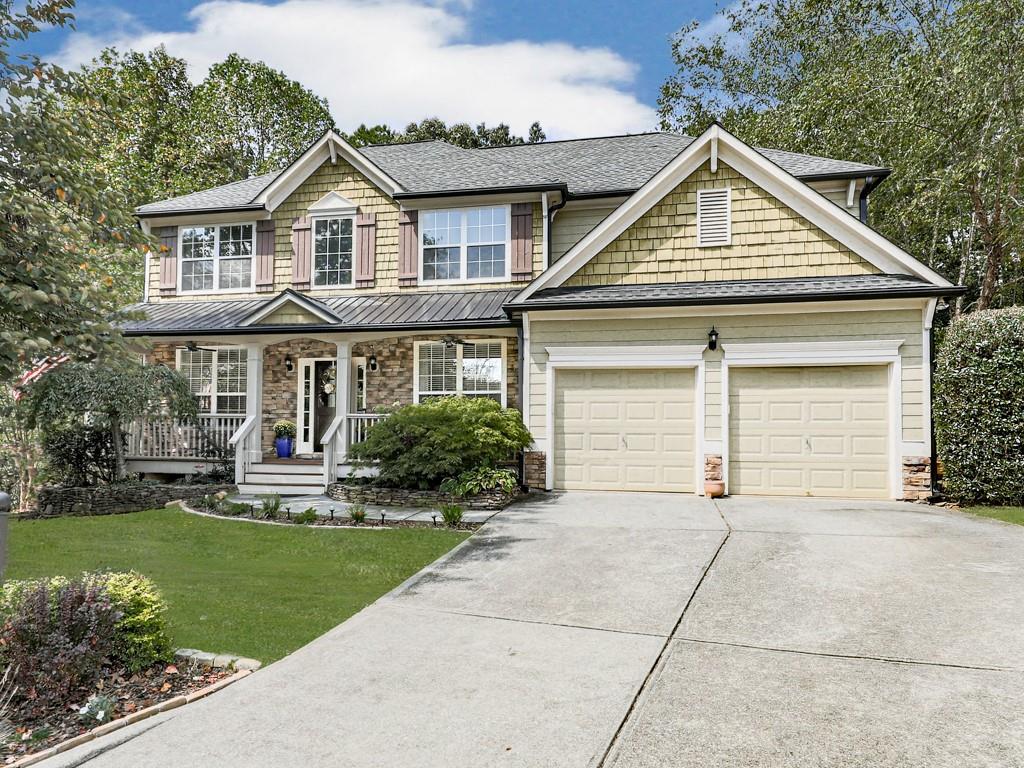 Welcome to this stunning move-in ready craftsman style home, nestled in a peaceful cul-de-sac and designed for both comfort and style. Rocking chair front porch, perfect for morning coffee or evening relaxation. This home offers 5 bedrooms, 4 full bathrooms, and a finished basement, this turn-key home is perfect for families who love to entertain and enjoy plenty of space. Bright and open floor plan featuring an office room and a separate dining room for formal gatherings. Main floor also has a bedroom and full bathroom. Kitchen is open concept with views to the living room. Nice kitchen island with plenty of space to entertain guests. Upstairs you will find an oversized master suite with a cozy sitting room, a custom walk-in closet, and luxurious bathroom. Secondary bedrooms are large and inviting. Step down to the basement where you will find additional living space, ideal for 2nd living room, media room, gym or play area. Basement also has a custom wet bar with sink - perfect when you have company over! Walk outside and find a freshly stained deck with views to the backyard. Covered patio and backyard is fenced in. This home blends craftsman charm with modern convenience, making it a rare find that won't last long. Conveniently located close to shopping, restaurants, schools, DOWNTOWN CANTON and THE MILL. Districted for the NEW CHEROKEE HIGH SCHOOL. Enjoy resort style living with top tier amenities, pools, tennis, pickleball, clubhouse, year-round events, trails, playground, basketball, fishing and more.