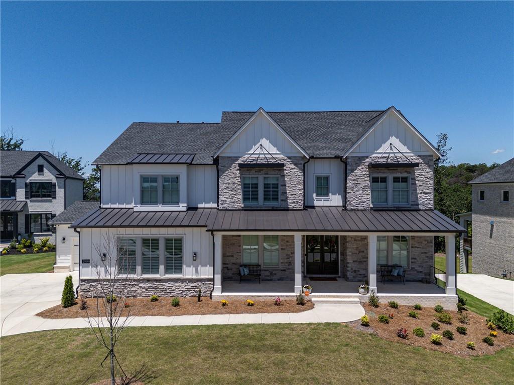 Sublimely elegant and intentionally functional, this home surpasses expectations. Upon entry, a sense of peace and tranquility immediately sets the tone. The views are private, impeccable, and awe-inspiring. Where high-end finishes meet refined elegance, the character of the home sets it apart from its contemporaries. The main level features a multigenerational suite complete with an ensuite full bathroom, bedroom, and sitting room. A true chef’s kitchen is outfitted with premium appliances. Built by Toll Brothers and further enhanced beyond its original modern design, the property showcases an array of bespoke upgrades. An Italian Plaster fireplace with open shelving, a thoughtfully designed prep kitchen functioning as a secondary kitchen, simplistically luxurious lighting, a custom-built library with premium fixtures, and a meticulously organized pantry with built-ins highlight the refined interior. Every bedroom includes an ensuite bathroom. The expansive primary bathroom boasts spa-like accommodations, including a massive shower with four shower heads, double-sided walk-in access, a rain head, and a frameless glass surround—designed to evoke a deep sense of serenity.
Overlooking pristine green forests and Sweat Mountain, the view is truly exceptional. Properties of this caliber rarely enter the market, and even less frequently as new builds. With over $200,000 in additional upgrades, the main kitchen is equipped with a stainless-steel Wolf dual-fuel gas range with griddle, Sub-Zero refrigerator, Wolf microwave, and a custom Batten hood vent. Kitchen cabinetry extends to the ceiling with glass fronts and integrated puck lighting. Silestone quartz countertops offer non-porous durability and high resistance to wear. Additional features include upgraded rocker light switches, 2 EV charging setups available. One is equipped with a 240V power outlet and the other is wired and ready for a Tesla Wall Connector, epoxy-coated garage floors, a walkout terrace level ready for further personalization, high-end Worthing Holland Park flooring, and under-cabinet kitchen lighting. The exceptionally tasteful and well-dressed powder room highlights designer wallpaper, bespoke accoutrements such as a designer mirror, wainscotting and electric torch lighting. Built-in office bookshelves, custom dining room walls, upstairs library shelving, and a functional mudroom enhance both aesthetic and utility. Custom closets throughout deliver exceptional organization and surpass typical expectations for homes in this category. Automatic screens on the rear of the home and plantation shutters on the front offer both convenience and aesthetic harmony. A single touch reveals the breathtaking morning views from the primary suite. Every element has been thoughtfully selected and meticulously executed.
Located in the highly regarded Davis, Mabry, Lassiter school district trifecta, this residence offers a rare opportunity to acquire a truly extraordinary home.