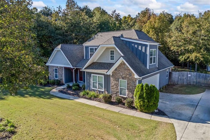 Gorgeous craftsman style home in quiet NO HOA neighborhood, located in Loganville school district! The property features an extra large poured driveway, outdoor shed for storage, chicken coop, rocking chair front porch, covered back porch, grilling patio and very private fenced in back yard. The home offers 4 bedrooms and 2.5 bathrooms which includes primary suite on the main level. Other features include crown molding throughout, eat in kitchen w/ breakfast area & bar, loads of cabinet and counter space, and a walk in pantry, separate dining room, two story family room includes beautifully stoned fireplace, oversized owners suite with trey ceilings, updated en suite w/ double vanities & separate tub/shower. You are just 1 mile from Ayer's splash pad, pickle ball court, disk golf and dog park. Just 10 minutes to both Loganville and downtown Monroe! Perfect location in highly desired Loganville School System! Close to shopping, restaurants and more.
