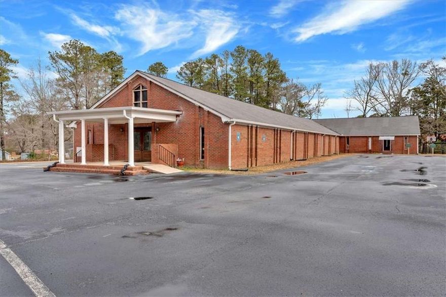 Situated in the rapidly growing commercial hub of Villa Rica, 35 McCurdy Rd offers an exceptional opportunity for corporate, medical, or institutional buyers. This expansive 3.94-acre property, featuring a 9,680 sq. ft. building, provides ample space for expansion, redevelopment, or adaptive reuse. Directly across the street from Tanner Medical Center Villa Rica and adjacent to Tanner Willowbrooke, the location ensures high visibility and ease of access for medical offices, corporate headquarters, or large-scale religious institutions. The property is easily rezoned for commercial or medical use, making it a seamless transition for buyers looking to develop in a high-demand area.    Beyond the existing structure, the size of the lot opens up endless possibilities, whether for additional medical office buildings, a corporate campus, or expanded facilities to support institutional or commercial needs. The property also includes a large, paved parking lot with 60 spaces, providing immediate accessibility for high-traffic operations. With room to expand and flexibility in use, this site is well-positioned to support a variety of commercial, healthcare, or professional developments. Villa Rica's ongoing growth and the property's strategic location near major healthcare facilities and business corridors make this a prime investment in West Georgia's evolving commercial and medical landscape.