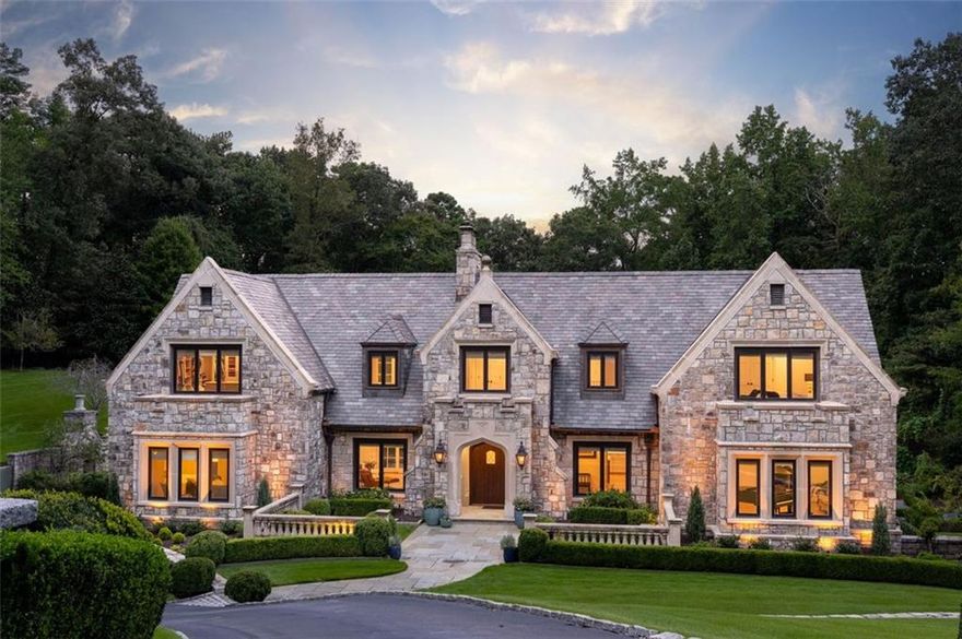 Stunning English Estate in Buckhead
Nestled on 2.15 acres of breathtaking grounds, this exquisite English estate offers resort-style living in the heart of Buckhead. From manicured gardens to a sparkling Pebble Tec pool, every detail evokes the serenity of a private European villa.
Inside, sunlight pours through newly installed windows, illuminating fresh paint, trim, and floors. Graceful arched doorways connect the living, dining, sitting, and sunroom, all opening to a sweeping slate terrace with panoramic garden views. The showpiece kitchen is a chef’s dream, featuring an oversized island, walk-in pantry, double wine cooler, and coffee bar. A main-level ensuite bedroom offers comfort and flexibility.
Upstairs, the generous primary suite is a sanctuary with a limestone fireplace, spa-inspired bath with double vanity, two lavatories, garden tub, and oversized shower, plus a walk-in closet and private beverage center. Three additional bedrooms, two bathrooms, a laundry room, and a versatile landing complete this level.
The lower level features a three-car garage (two tandem + one), mudroom, fitness room with rubber flooring, sauna, and full bath—with convenient access to the pool and gardens.
Exterior details include hand-carved granite stonework, a slate roof, working greenhouse, outdoor fireplace, limestone and bronze statuary, and a cascading fountain—creating a timeless sense of grandeur.
The home is only minutes from vibrant shopping, dining, and the recreation options of central Buckhead. Easy access to I-75 and very close proximity to Lovett, Westminster, and North Atlanta High.
This is more than a home—it’s an everyday retreat. Schedule your private tour and allow time to stroll the grounds, where each corner reveals the artistry and tranquility of estate living.