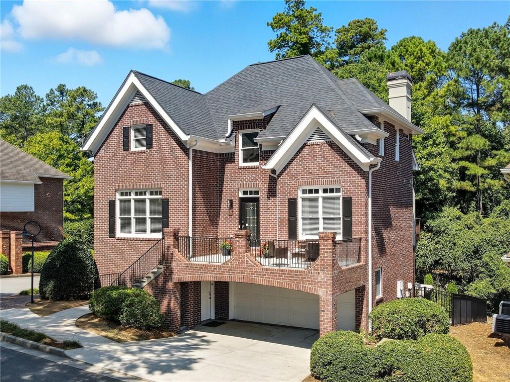 Discover this stunning four-sided brick showpiece in the coveted enclave of Fairway Gardens at Lenox Park. Lenox Park community offers various private walking trails, expansive green spaces, and even a private duck pond! All of this walking distance to the sweeping views of the Buckhead skyline and a lifestyle that blends elegance, convenience, and comfort. Step inside the soaring two-story foyer to find a bright, open living area drenched in natural light and anchored by a custom-designed, floor-to-ceiling bookshelf that’s nothing short of spectacular. The chef’s kitchen features expansive granite counters that flow into a generous barstool dining area—perfect for everyday living or entertaining. The main level also offers a flexible bedroom/office with charming arched wooden doors and a clever custom Murphy bed encased in floor-to-ceiling cabinetry, making it as practical as it is beautiful. Upstairs, retreat to the luxurious primary suite with its oversized walk-in closet and spa-like bath complete with double vanity, soaking tub, and separate shower. A spacious secondary suite with its own walk-in closet and en-suite bath completes the upper level. The terrace level is an entertainer’s dream—a stylish built-in bar with shelving, a full bedroom and bath, and seamless access to a brand-new outdoor patio designed for gatherings under the stars. With over $100K in thoughtful upgrades, including a new roof (2023), fresh paint, upgraded lighting, new patio, professional landscaping, full basement remodel, and more, this home is truly move-in ready. And the location? Unbeatable. Walk to MARTA, Lenox Mall, Phipps Plaza, and some of Atlanta’s best restaurants and shopping and parks—all from your private, serene community. This is more than a home—it’s a lifestyle. Don’t miss it!