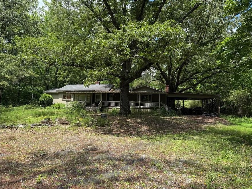 9.7 acres in the heart of west cobb... perfect for a large estate with possible multiple building sites, could be developed into 80,000 lots without sewer, or if buyer obtains sewer permit could be possibly developed into 15-16 lot R20 community with no rezoning required.  Seller willing to allow time to acquire sewer easements if that is route buyer wants to take.  No soils testing done, small pond at front of land is partially on this acreage, boundary survey and disclosures in documents. Call to get access to gate code will only give out code to confirmed people visiting site for consideration. Let me know if you want to walk the home, I do not currently have keys for that as the value is in the land not the home.