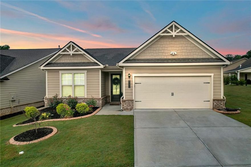 Welcome to 2292 Knob Creek Rd in the vibrant Saddlebrook 55+ community! This four-year-young, one-level home offers an open-concept floor plan with soaring 12-foot ceilings throughout—and a stunning 14-foot ceiling in the living room, complete with a cozy, single-switch gas fireplace. From the moment you step through the impressive 10-foot front door, you’ll appreciate the light-filled, spacious layout that’s ideal for both entertaining and everyday living. The chef’s kitchen features granite countertops, a tile backsplash, stainless steel appliances, double ovens, a 4-burner gas stove, and a large island with breakfast bar seating. Ample cabinetry—including newly installed sliding shelves—makes storage and organization effortless. An oversized laundry room and a 2-car garage with a dedicated storage area add to the home’s functionality. The private primary suite includes separate his-and-hers walk-in closets and a spa-like bathroom with double vanities, a tiled walk-in shower, and a private water closet. Step outside and enjoy your fully fenced backyard with a fruit-bearing peach tree, a covered patio with privacy shades, and an enclosed all-weather sunroom—perfect for year-round relaxation. Community amenities include: swimming pool, pickleball and bocce ball courts, walking trails, lake, dog park, and year-round lawn maintenance. Conveniently close to shopping, dining, and medical facilities, this move-in ready home is a must-see for those seeking space, comfort, and an active lifestyle in a prime Snellville location. Up to $24,000 in Down Payment assistance available to qualified Homebuyers through Preferred Lender!