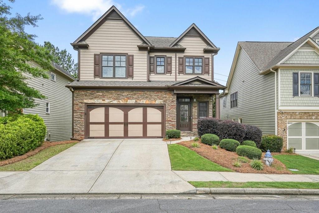 Three level home in Cornerstone Park with amazing backyard! Truly a retreat fenced with over $15K in outdoor ambient lighting, beautiful landscaping, shaded patio and custom stairs to connect upper level with screened in back porch. Meticulously maintained with thoughtful upgrades, details and character. Hardwood floors flow throughout the main level, where you'll find a spacious kitchen with an oversized island perfect for entertaining. A large walk-in pantry with custom shelving will make the at-home chef happy along with stainless steel appliances, beautiful cabinetry, undermount lighting, and lots of countertop working space. The kitchen, family room, and open dining area are truly the heart of the home and perfect for entertaining. Step outside on the covered porch room for relaxing evenings and grill on the separate uncovered deck on the kitchen level. The family room with stone fireplace framed, stone hearth, custom built-in bookcases and storage cabinets. Upstairs, retreat to your oversized owner’s suite complete with a luxurious bath, separate tub and shower, and TWO custom walk-in owners closets. Every closet in the home has been outfitted with custom sensor lighting and built-ins for ultimate organization. Large secondary guest bedrooms with guest bath in the hall and a light and bright laundry room with custom built-ins complete the upper level. The fully finished basement offers a large media/rec room, a sleek wet bar with copper hammered sink, and a full bath—ideal for hosting guests or game nights. Retreat to the private fenced backyard oasis with over $15K in outdoor ambient lighting, beautiful landscaping, shaded patio under the deck and custom stairs to connect upper and lower levels of outdoor living space. NEW (2024) Navian Tankless hot water heater, NEW A/C systems (2021 and 2024) storage room, NEW garage door updates and camera system (2024). Maintenance is easy and includes front and back yard maintenance included in the HOA and you'll have peace of mind with the programmable Rainbird Irrigation system with front and rear zones. Located in a sought-after community with top-rated schools, conveniently located off of Hwy 92 and 15 min to Downtown Roswell, 25 min to Avalon and DT Alpharetta. This one won't last long!