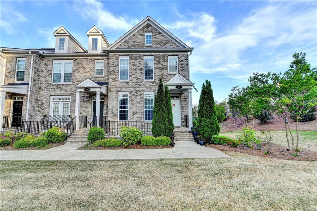AVALON Walking Distance! Welcome to 611 Hanlon Way, a charming 3-bedroom, 3.5-bathroom home in the heart of Alpharetta, offering an unparalleled lifestyle and prime location. This beautifully designed residence is minutes away from Avalon, with one spacious decks and a welcoming front porch, perfect for enjoying the stunning views of this vibrant area as it is CORNER UNIT. Nestled on the most coveted lot in the community, this home offers breathtaking views of Avalon and easy access to all the amenities that make Alpharetta one of the most desirable places to live. Located just over a mile from "The Gathering," a highly anticipated $1 billion mixed-use project currently under construction, you'll be at the center of future shopping, dining, and entertainment venues. The convenience doesn't stop there-this home is also close to GA-400, Wills Park, Downtown Alpharetta, the Alpha Loop, and is situated in the highly sought-after Milton School District. Living here means you'll be at the heart of everything Alpharetta has to offer. As you step into the main level, you'll be greeted by a welcoming foyer area, leading to a guest bedroom and full bath-perfect for visitors or a home office.The main floor features an open-concept design, seamlessly connecting the living room, kitchen, eat-in area, and dining room. Enjoy your morning coffee or evening cocktails on the back patio, which offers scenic views of Avalon and the community. Upstairs, you'll find two big amazing bedroom, perfect for an office or playroom, along with the primary suite, which boasts a dreamy bathroom and two spacious closets.With move-in ready conditions, 10-foot ceilings, and hardwood floors, this home is the perfect blend of modern luxury and convenience.