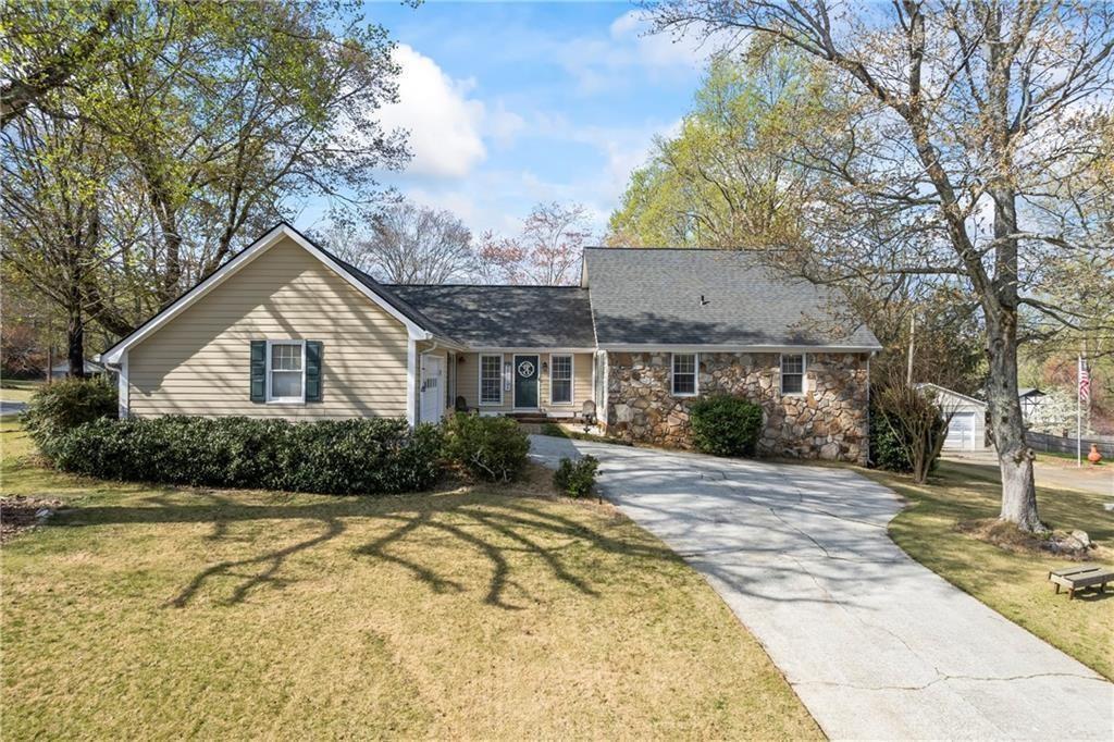 Welcome to this beautifully maintained home located in the highly sought-after Brookwood High School district. This charming two-story residence features four spacious bedrooms and two full bathrooms, offering a perfect blend of comfort, character, and functionality. Situated on a premium one-acre corner lot, the property provides ample outdoor space and exceptional privacy. The home includes a partially finished basement with exterior entry, ideal for storage, a workshop, or future expansion. On the exterior, you’ll find a custom-built side porch—a perfect retreat for enjoying summer evenings. The yard also includes a rope tire swing, making it a wonderful outdoor space for children. The fully fenced backyard features a custom pergola, providing shaded seating and a tranquil setting to relax and take in the beauty of the property. Inside, the home boasts brand-new flooring throughout, with three bedrooms conveniently located on the main level, including the primary suite. The kitchen offers ample cabinet and pantry space, catering to all your storage and cooking needs. The family room is a true centerpiece, highlighted by a floor-to-ceiling stone fireplace and cathedral ceilings with exposed beams, adding warmth and architectural charm to the space. The fourth bedroom is located upstairs, offering a private and versatile space ideal for guests, a home office, playroom, or media room—the possibilities are endless. The home also features a half basement with full electrical access, perfect for storing lawn equipment or customizing to your needs. Additional highlights include a brand-new roof installed this year, and a prime location close to major shopping, dining, and amenities—all within a peaceful, established neighborhood. This corner-lot gem is a rare find that combines thoughtful updates, unique character, and unbeatable location. A must-see for any buyer in today’s market.