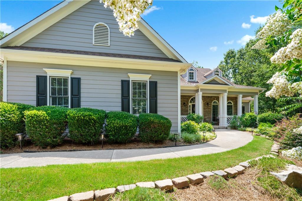 Rare find in Sweetwater Creek subdivision! Welcome home to this custom-built, one-owner RANCH on a FULL daylight BASEMENT, perfectly positioned on a large, private lot backing up to Sweetwater Park on Lake Allatoona—just a short walk to the lake!
This 4-bedroom, 3.5-bath home features a separate dining room, office/formal living room, and family room with soaring coffered ceilings and a stone fireplace, open to a breakfast room and gourmet kitchen with granite countertops, stainless steel appliances, and plenty of storage. The primary suite on the main includes a vaulted tray ceiling and a beautifully updated ensuite bath with double vanity, separate whirlpool tub, glass shower, and a large closet. Two additional bedrooms and a full bath are on the main floor, and just off the laundry area, a private staircase leads to the bonus fourth bedroom and full bath upstairs, along with easy attic storage access.
The main-level laundry room includes a sink and built-in cabinetry for added convenience. An extra-large two-car garage with side entry door offers easy access, and ample driveway parking offers convenience for family and guests. Additional features include hardwood floors, beautiful crown molding, a sun porch/screened porch and sundeck area, plus a LARGE unfinished basement stubbed for a bath with a fantastic layout for future finishing. The basement also features two sets of French doors and two breaker boxes. The backyard is private and level, with a generous patio for more outdoor entertaining.
Privately situated on a manicured lot with mature trees and a welcoming rocking chair front porch, this home is just minutes from Lake Allatoona, Sweetwater Creek State Park, and all the amenities Cherokee County has to offer.