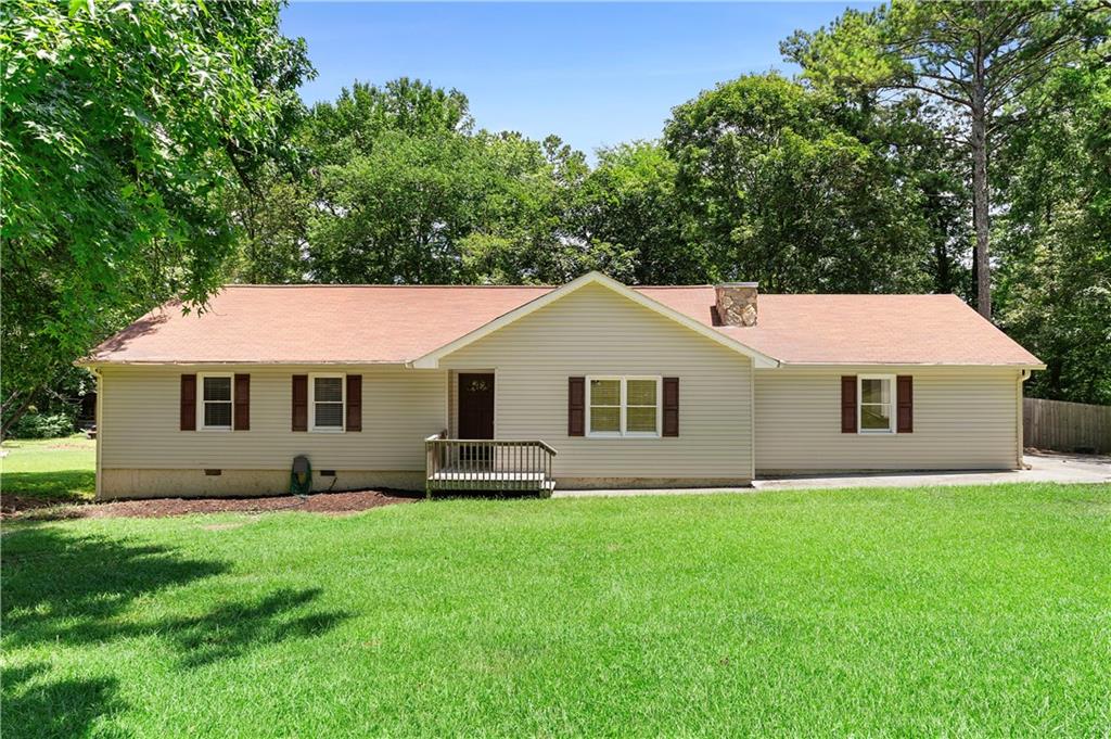 Beautifully updated 3 bed, 2 bath ranch in Cartersville. Come check out this newly renovated home. The vibrant living room features a cozy masonry fireplace and wainscot paneling. The kitchen is stunning, with crisp white cabinetry, sleek stainless steel appliances, stone countertops, a tiled backsplash, and modern black hardware. The primary suite is a private retreat with a fully renovated en-suite bathroom, complete with a new shower and vanity. The second bathroom is similarly updated. Other highlights include a 2-car garage, back deck, and a large fenced backyard, perfect for relaxing or entertaining.