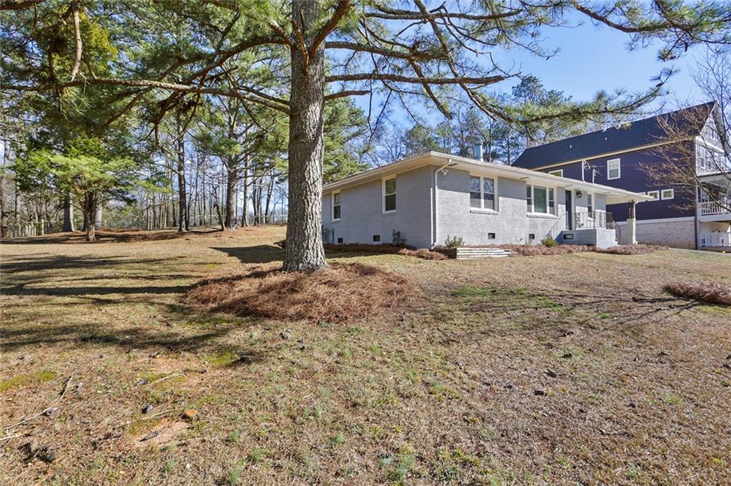 Completely updated, charming home in Downtown Smyrna! Amazing rental opportunity available for long term or short term rental, furnished or unfurnished (pricing may vary based on lease length and furnishings). This is not your typical Grandma's ranch... If you are looking for light, bright and renovated do not miss this gem! White oak light wood flooring throughout, recessed lighting, updated kitchen with stone counters and stainless appliances open too separate dining room and oversized family room with loads or natural sunlight. The primary suite features a private bath and roomy custom closet! Two additional guest rooms are oversized for this style home with nicely sized closets. This homes was recently renovated to include new driveway, new windows, electrical, plumbing, kitchen and bathrooms! It features hardwood floors and recessed lighting throughout. Situated on a fenced, oversized lot adjacent to the city center and the golf course this home has easy access to 75, 285 and Hartsfield Jackson Airport. If the outdoors is your jam you will love the meandering treelined streets of Williams Park and the proximity to The Silver Comet Trail. Just a 5 minute Uber ride to The Battery and Truist Park you will enjoy the best in entertainment and recreation from this quiet, tucked away home. This home is available any way you want it... furnished, unfurnished, long term or short term.