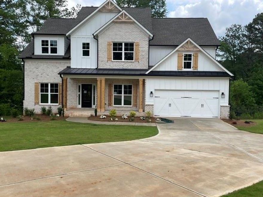 Explore the impressive Garrison Craftsman-style floor plan featuring 5 bedrooms and 4 baths. The home welcomes you with formal living and dining rooms that seamlessly flow into the kitchen, highlighted by a spacious island. The breakfast area offers a delightful view of the private backyard from the covered deck that overlooks beautiful Powers Lake. Inside, you'll find white shaker cabinets, a double oven appliance package, and elegant quartz countertops. The main living areas feature gleaming hardwood floors, adding a touch of luxury to the space. On the main level, there's an office or bedroom along with a full bath for added convenience. Upstairs, you'll discover the spacious master suite, a bedroom with its own private bath, and two generously sized bedrooms that share a bathroom. The large lot provides privacy and best part there are no HOA fees! Beautiful Enclave of 4 homes tucked away on private drive. RELAX ON YOUR COVERED DECK WITH AMAZING VIEW ON POWERS LAKE. A DREAM COME TRUE FOR THOSE WHO WANT A QUITE AND PRIVATE BACKYARD!!!