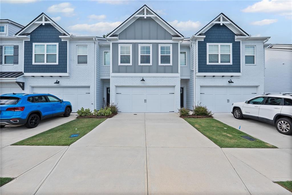 Discover the epitome of contemporary living in this stunning, townhome designed to captivate your senses. With meticulous attention to detail, revel in the allure of this 3-bedroom, 2.5-bathroom home, offering an abundance of natural light and a wealth of thoughtful features. Step inside and be greeted by the airy, open concept floor plan, featuring a well-appointed kitchen on the main level. The kitchen boasts sleek granite countertops, pristine white cabinets, and top-of-the-line stainless steel appliances, including a side-by-side refrigerator. Elegant hardwood flooring graces the main level, while plush carpeting adds warmth and comfort to the upper floors. Ascend to the second floor and discover a generously sized loft, perfect for creating a second living room, a home office, or any other space your imagination desires. This versatile area opens up a world of possibilities for customization Retreat to the master suite, where you'll find a masterfully designed bathroom that includes a separate tub and shower, a double vanity, and a spacious walk-in closet. It's your personal sanctuary for relaxation and rejuvenation. Two more spacious bedrooms on the upper level provide ample space for family, guests, or creative use of your choice. The fully fenced yard is a haven for pet owners, offering a secure and private space for your furry friends to roam. The lawn care is thoughtfully maintained by the HOA, ensuring your outdoor space remains pristine and hassle-free. Enjoy the convenience of a 2-car garage and a driveway with space for two additional cars, ensuring that parking is never a concern. Nestled in a beautiful new community in Conyers, this townhome is conveniently situated near shopping, grocery stores, and the I-20, making daily errands and commutes a breeze.