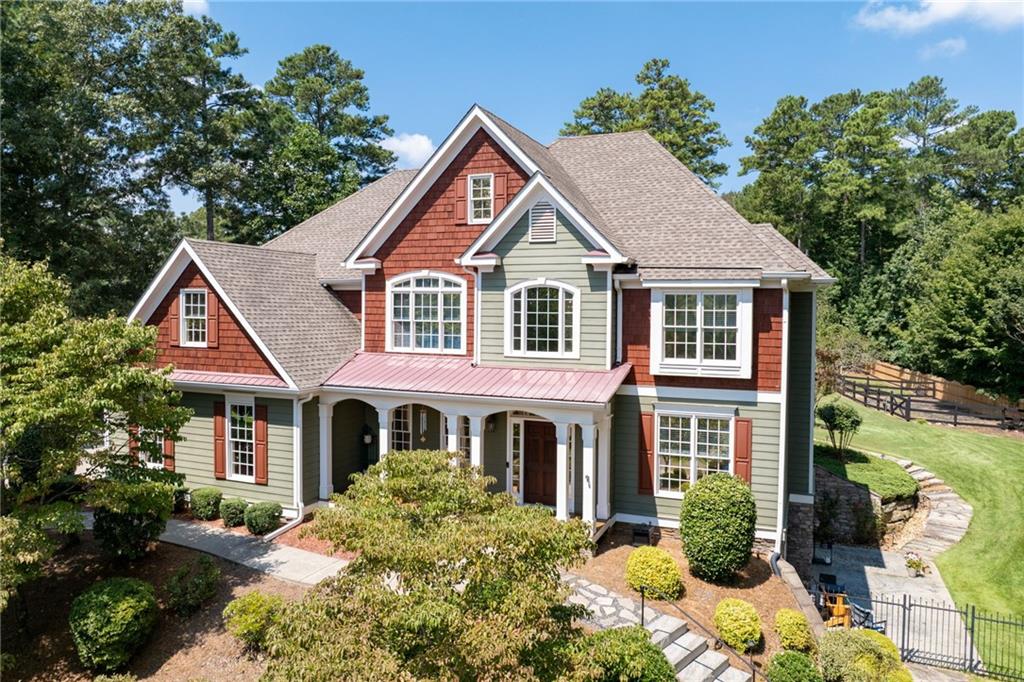 Luxury, Privacy & Thoughtful Upgrades on 2 Acres - Discover a rare opportunity to own a custom estate home in one of Canton’s most sought-after communities - an intimate enclave of just 11 homes. This masterpiece offers 5 bedrooms, 4.5 bathrooms, a finished walkout terrace level, a huge workshop/potential ADU, and an incredible 2-acre private lot with no detail overlooked. From the moment you arrive, the home’s stately curb appeal is undeniable—lush landscaping, a mechanical gated entry, and an inviting covered front porch set the stage. Step inside to a dramatic two-story foyer and living room with soaring ceilings, abundant natural light, and views of the backyard oasis. The gourmet kitchen is a chef’s dream—featuring granite and quartz countertops, high-end appliances, a large island, custom cabinetry, and seamless flow into the dining and keeping areas. The home’s main level is designed for both elegant entertaining and comfortable daily living, with upgraded lighting, fresh interior paint, and new fixtures and faucets throughout. The owner’s suite is a private retreat, complete with a spa-inspired bathroom and custom closet system. Upstairs, you’ll find generously sized secondary bedrooms and bathrooms, while the fully finished terrace level offers a home theater, wet bar, office, and abundant space for recreation or guests. This property is brimming with premium upgrades, including:
Thermal-tinted windows for energy efficiency, Updated electrical switches & outlets, New carpet throughout the home, Epoxy-coated floors in the 3-car garage with new garage door openers, Wood-burning fireplace conversion for cozy ambiance, Custom railing added to front steps, Motorized gate and fencing for security and privacy, Custom closet systems. The detached 30×40 climate-controlled workshop is a rare find—spray-foam insulated with RV-ready power and tall ceilings—perfect for hobbies, car collection, or business use. The potential accessory dwelling unit (ADU) now boasts its own new septic system and is ready for build-out, with construction plans included. Outside, enjoy your own private retreat with professionally landscaped grounds, fruit trees, berry bushes, a garden area, irrigation, and plenty of room for a future pool. Located in the top-rated Sequoyah High School district and just minutes to shopping, dining, and I-575, this home delivers luxury, privacy, and unmatched functionality. Schedule your private showing today—homes of this caliber rarely hit the market in Canton.