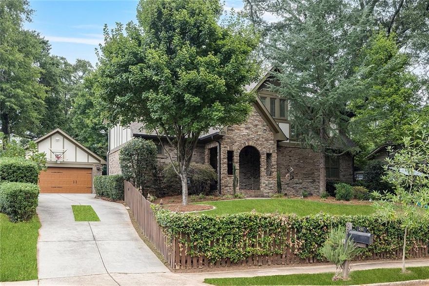 Storybook Tudor in the Heart of Oakhurst Village! Walkability score is a 10! Charming brick front porch with swing welcomes you into this beautiful home just blocks from Oakhurst Village—newer construction perks blended with timeless old-world charm. Just freshly painted throughout the interior! Perfect for entertaining, the chef’s kitchen features a large island, convenient pot filler behind the cooktop, beverage/wine cooler, peninsula with seating, and it flows seamlessly into the fireside living room with gas logs and built-ins, as well as the spacious dining area. A large mudroom and walk-in pantry keep life organized. A guest suite on the main level offers flexibility for visitors or a home office, while the heated and cooled four-seasons screened porch provides year-round enjoyment overlooking the fenced, turfed backyard. Upstairs are four generous bedrooms, a jack and jill and another secondary bedroom with an ensuite bath—all with hardwood floors.  The serene primary retreat with custom walk-in closet and spa-like bath with a stand alone soaking tub and luxurious shower. Convenient upstairs laundry room with large utility sink. Additional highlights include a two-car detached garage with built-in and stand-alone shelving. Located in the highly sought-after Decatur City Schools zone, this home is a short stroll to Oakhurst’s restaurants, Oakhurst City of Decatur Pool, coffee shops, market, parks, concerts, and festivals.