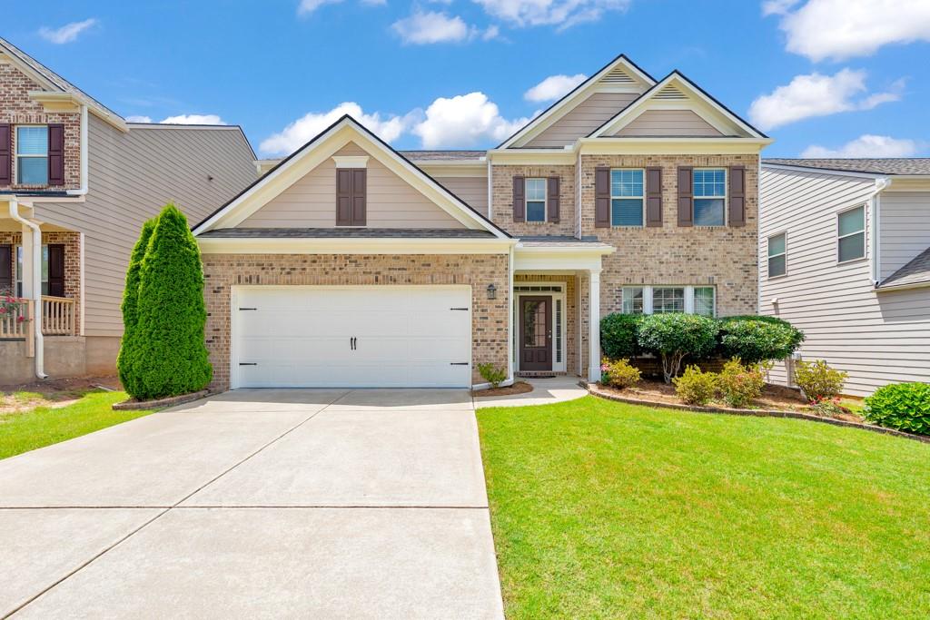 Welcome home to this spacious 4 bedroom, 3 bathroom East-facing gem in the desirable Waterbrooke community! Recent upgrades include a new roof, appliances, carpet, and fresh interior and exterior paint! A welcoming foyer greets you upon entry, with a formal dining room to the right—perfect for entertaining. The fireside family room flows effortlessly into the kitchen, featuring stone countertops, a breakfast bar, a walk-in pantry, and a sunny breakfast room. A convenient main level bedroom and full bathroom are ideal for guests or multigenerational living. Upstairs, you'll find a large bonus room that can serve as a home office, playroom, or flex space. The oversized primary suite is a true retreat with tray ceilings, a spa-like ensuite bathroom with dual vanities, a soaking tub, separate shower, a massive walk-in closet, and access to a private covered deck overlooking the backyard. Two additional bedrooms share a full bath, and the laundry room is conveniently located on the upper level. Enjoy outdoor living on the covered patio overlooking the spacious, fenced-in backyard. Additional features include an attached 2-car garage and access to amazing community amenities: pool, playground, tennis courts, and clubhouse. Located in the top-rated Denmark High School district with easy access to Downtown Alpharetta, Halcyon, Fowler Park, major roadways, and an abundance of shopping and dining options—this home truly has it all!