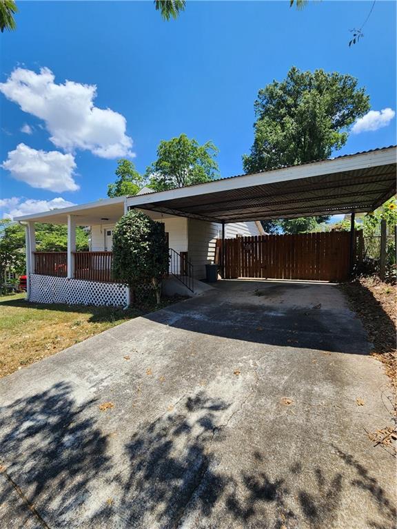 -All Utilities Included-Charming bungalow-style home built in 1949. It features 2 bedrooms, 1.5 bathrooms. Includes hardwood floors, a decorative fireplace in the living room, and a spacious laundry/mudroom. The exterior includes a covered front porch, a glass-enclosed back porch with ramp access, a fenced in shared backyard, and a 1 car carport. The property is conveniently located within walking distance to historic Marietta Square**12 month minimum lease term. All occupants over the age of 18 MUST complete an application to be considered for the property. App fee is $75 per adult and paid by C/C online. **Multiple applications may be considered at one time** This property does NOT accept housing vouchers.