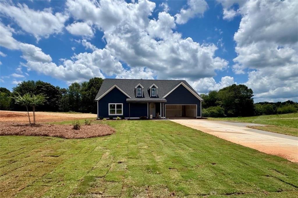 Introducing this Charming 4BR/3BA 1.5 Story Primary Suite on Main Level Home on Over 1+ Acre with Luxurious Finishes and Peaceful Pasture Views. Welcome home to this beautifully crafted 4 bedroom, 3 bathroom retreat set on a picturesque 1+ acre pasture lot. From the inviting covered front porch to the covered back patio with stunning tongue and groove ceilings, every detail is designed for comfort and timeless appeal. Step inside to find luxury vinyl plank (LVP) flooring throughout-no carpet anywhere-an airy open-concept layout, and a cozy wood-burning stone-front fireplace that anchors the main living space. The heart of the home is the chef-inspired kitchen, complete with a freestanding kitchen island, granite countertops, soft-close cabinetry, and contemporary finishes that exude style and functionality. The sink is located in the kitchen island overlooking your main living space, perfect for entertaining & watching THE BIG GAME! The owner's suite features a tray-ceiling, spa-worthy bath complete with huge double vanity, oversized tiled super shower for ultimate relaxation, & expansive walk-in closet that connects to your laundry for ultimate convenience and privacy. he guest bath on main offers 2-sinks perfect for multi-generational living. Upstairs, you'll experience an oversized guest suite perfect for additional guests, home office space, or craft room, not to mention another full bath! Every home includes a full builder-backed 1-year warranty and a 2-part orientation and walk-through process to ensure a smooth, confident transition into your new home. *As an added bonus, take advantage of special incentives when using our preferred lender-making your path to homeownership even more rewarding! This is more than just a home-it's where modern comfort meets classic countryside charm. Come live the Creekstone lifestyle today! Welcome to Creekstone - A Hidden Gem in the Heart of Hartwell, Georgia. Discover Creekstone, Hartwell's newest luxury lake-town community nestled off Jane Road, just minutes from the charm of downtown Hartwell and the scenic Reed Creek area of Lake Hartwell. Designed for those who crave the serenity of country living without sacrificing convenience, Creekstone offers a rare blend of rural elegance and modern accessibility. Set on expansive 1+ acre pasture lots, this picturesque enclave features beautifully crafted ranch and 1.5-story homes starting from the high $300Ks-each home thoughtfully positioned to maximize privacy, views, and connection to nature. Whether you're enjoying a quiet evening on the porch or launching your boat at one of the nearby Lake Hartwell public ramps, Creekstone invites you to savor every moment. Just minutes to downtown Hartwell's boutiques, restaurants, farmers markets, and live music. Close to Reed Creek, one of Lake Hartwell's most desirable recreational corridors. Quick access to shopping, dining, and everyday essentials without the hustle of city living. Zoned for highly rated North Hart Elementary School, a favorite among local families. Only a short drive to Hart State Park, boat launches, and walking trails. Easy commute with direct access to I-85, connecting you to Atlanta, Greenville, Athens, Clemson, and beyond. Creekstone is more than a neighborhood-it's a lifestyle rooted in natural beauty, community pride, and lake-town luxury. With some of the prettiest and most desirable lots in Northeast Georgia, Creekstone offers the rare chance to live surrounded by peaceful pastures while staying connected to all the best Hartwell has to offer. Come home to Creekstone-where the lake life, land, and luxury come together.
