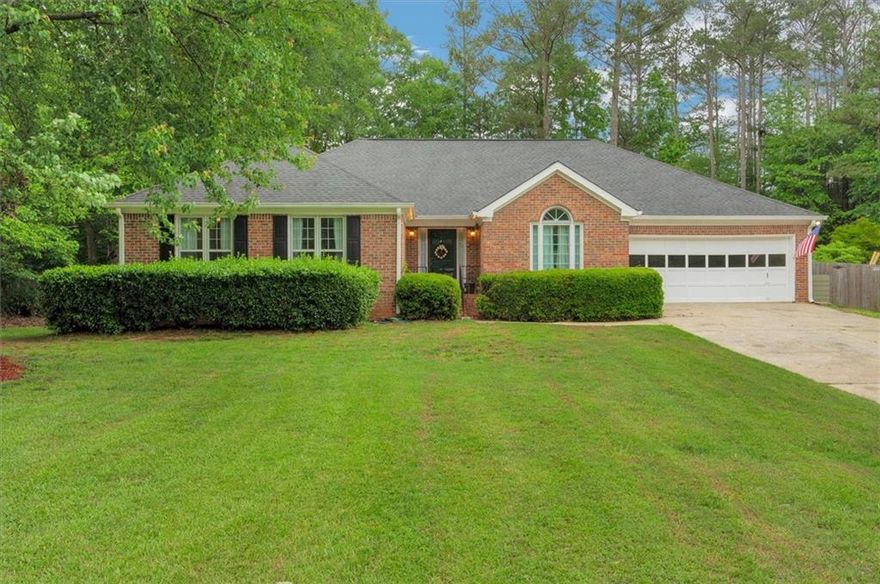 This beautiful ranch home is located in the highly sought after neighborhood of Lee's Crossing. This active neighborhood offers swimming, tennis, and pickleball courts. The house has been fully renovated and freshly painted inside. You enter into the front foyer to a great room with a vaulted ceiling and a brick fireplace. From the great room, it flows into a magnificent sun room with large windows overlooking the back yard. The kitchen is equipped with a gas stove and KraftMaid custom cabinets with gorgeous granite counters. There is an open flow from the kitchen to the dining room and the keeping room. There is a second fireplace in the keeping room. The laundry room that holds new upper cabinets and wash sink leads out to the oversized garage with room for a workshop. There are three very spacious bedrooms. The master suite has a trey ceiling with a large custom en-suite. The en-suite has a double sink marbled vanity, a large walk-in shower with a free-standing, soaking tub. The closet is spacious and found within the en-suite. The two spare bedrooms have ample closet space. All bedrooms had new carpet installed two years ago. The spare bath has a granite countertop with one sink. The shower/tub has a glass door. The bathroom also has a linen closet. There are two attic entrances with a huge storage area. The back yard is a lovely oasis. The new deck spans most of the back of the house. The deck partially wraps around the 1,000 gallon Dr. Wellness Swim Spa. A few steps off the deck, there is a patio with a fire pit to roast marshmallows and gaze at the stars. There is a shed perfect for storing lawn equipment. This property is a must-see in a great neighborhood!