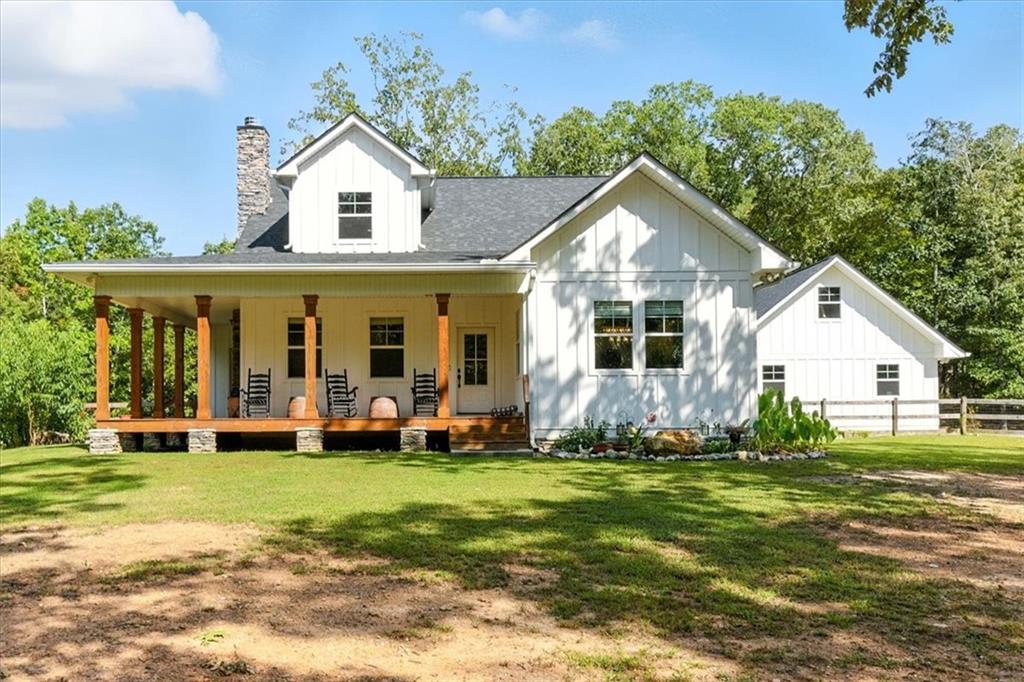 Tucked away on a serene 10-acre wooded lot in Bartow county, this custom-built modern farmhouse is a true private retreat. From the moment you arrive, the wraparound porch and classic farmhouse architecture invite you to slow down and savor the surroundings. Constructed in 2020 with 2x6 framing and Hardiplank siding, this home blends rustic charm with modern sophistication and energy efficiency.
Step inside to soaring vaulted ceilings, an open-concept layout, and natural light pouring through the windows. The living room centers around a stone fireplace, while the loft above, with its built-in bookcases, makes the perfect reading nook or study space. The kitchen offers granite countertops, stainless steel appliances, and crisp white cabinetry, marrying farmhouse warmth with modern style.
The primary suite is thoughtfully placed on the main floor, providing ease, privacy, and comfort — a standout feature for today’s buyers. Two additional bedrooms and bathrooms complete the home. The partially finished basement adds exciting possibilities, with 2 oversized rooms plus a garage space with a boat door — ideal for hobbies, storage, or finishing into a spacious media room.
Outdoor living is equally special, with a screened porch, fire pit area, fenced yard, and a custom chicken coop ready for your homestead dreams. The grounds also feature fruit trees and bushes, including blueberry, apple, pear, nectarine, and apricot — perfect for enjoying fresh harvests right at home. The detached 2-car garage is sheetrocked, features 220V power, and offers additional attic storage above. The 24x26 workshop with spray foam insulation, power and a stubbed bathroom expands your possibilities — perfect for projects, hobbies, or extra storage.
Surrounded by trees, this property offers peace and privacy, yet is only 1.5 miles from the world-class amenities of Barnsley Resort — including fine dining, golf, spa, and outdoor activities. This property isn’t just a home, it’s a lifestyle.