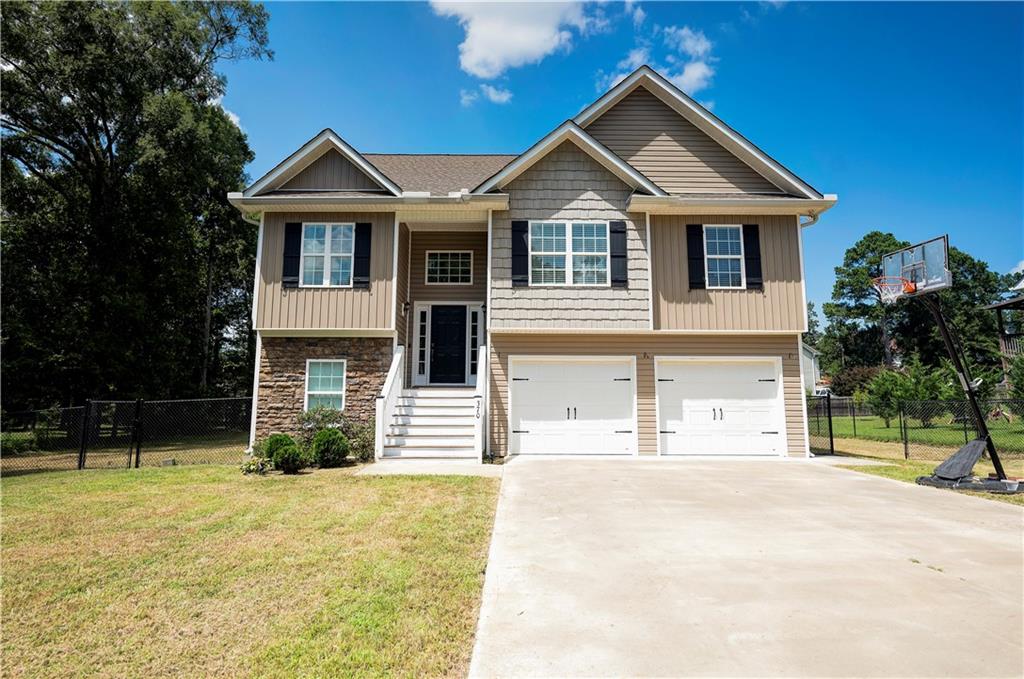 MESMERIZING IN MEADOWBROOK AND MOVE-RIGHT-ON-IN-READY! Stately split-foyer in picture perfect condition located inside CALHOUN CITY LIMITS! The breathtaking facade greets you with timeless CURB APPEAL, featuring faux stone, vinyl- shake and board-and-batten accents, ARCHITECTURAL-STYLE ROOFING, onyx shutters, and charismatic carriage package on the DOUBLE GARAGE DOORS. The front entry accesses the staircase, which travels up to the home's main level. Inviting living room welcomes guests with CATHEDRAL CEILINGS, RECESSED LIGHTING, and SOLID SURFACE FLOORING. The generous galley-style kitchen is equipped with SUBWAY TILE BACKSPLASH and STAINLESS APPLIANCE PACKAGE. The OWNER’S RETREAT includes a sizable bedroom, which is adorned with TRAY CEILINGS, and TWO WALK-IN CLOSETS are in place for many fashions. PRIVATE ENSUITE features a SOAKING TUB and SEPARATE SHOWER. Travel down to the LOWER LEVEL, which is impressive to say the least! Spacious FLEX ROOM/4TH BEDROOM opens to FULL BATH, and also has EXTERIOR ACCESS. Enjoy al fresco dining and outdoor entertaining on the BACK DECK, which overlooks the SPACIOUS, FENCED BACKYARD. This home has gorgeous features, including SOLID SURFACE FLOORING THORUHOUT, and as added perks, the WASHER, DRYER, and REFRIGERATOR can be included with purchase! There is also neighborhood access to Calhoun Primary and Calhoun Elementary Schools. Enjoy all this property has to offer with NO HOA FEES! Welcome Home to 370 Wildwood!