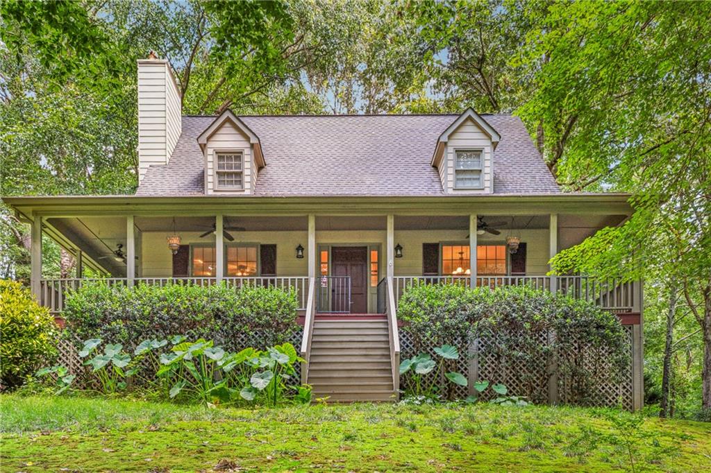 Assumable loan at 3.125% rate - This isn’t your run-of-the-mill suburban home — it’s a front porch craftsman cottage with personality. Down a picturesque driveway, the home is tucked in what feels like a park-setting. Located in Springfield Place subdivision, this 3 bedroom, 2.5 bath home feels like a vacation escape but keeps you close to all the conveniences of Woodstock. The primary suite is on the main level, complete with a beautifully renovated bath Pinterest-style bath and walk-in closet. Convenient access to the wrap around porch is right off the primary suite - perfect for morning coffee or taking the dogs out. The living room gives you cozy fireside vibes, and the kitchen has newer appliances, and all the conveniences, with a little bit of rustic charm. Upstairs you’ve got your pick - two large bedrooms flank another full bath with skylight. Outside, the yard is big, green, and shaded — perfect for a trampoline, firepit nights, or just hanging out under the trees. There’s also a partially finished, daylight basement and a two-car garage for all your gear. Currently a workout space, this has been a workshop (with convenient double door access leading directly to the garage. Also - there’s a fantastic office with a door right out to the driveway. No need to walk around to the front door if you’re working from home, or need to step out for a call and some fresh air. The best part? Springfield Place is a swim/tennis neighborhood, and you’re minutes from Downtown Woodstock, trails, concerts, shopping centers galore, and everything else that keeps the city buzzing. Think cottage charm meets neighborhood living — and yes, it’s just as good as it sounds. Inquire about the assumable loan at 3.125%