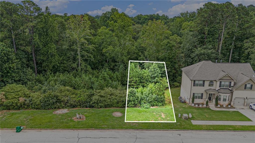 Fantastic opportunity in the well-established neighborhood of Parks at Stonecrest with its great amenities. Lot is zoned residential, and utilities are ready to go. Location, location, location-just minutes from Stonecrest Mall and I20. Seller would prefer to sell 7974 and 7980 together. 7974 and 7980 could be bundled into one sale.