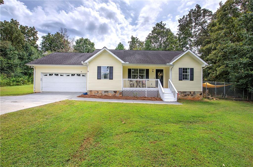 Welcome to 191 Frix Lane in Calhoun, a charming ranch-style home offering comfort, convenience, and plenty of space inside and out. Set on nearly an acre, this 3-bedroom, 2-bath property greets you with a classic rocking-chair front porch that enhances its curb appeal. Inside, the home features a bright and inviting living room that flows into a spacious dining area and a well-appointed kitchen with generous cabinet storage. A large laundry room, practical mudroom, and attached two-car garage add everyday convenience. The bedrooms are thoughtfully arranged to provide comfort and privacy, while the open layout creates a natural flow throughout the home. Step outside to discover the expansive backyard, perfect for entertaining, gardening, or simply enjoying peaceful afternoons in your own private retreat. With its wide-open lawn and quiet surroundings, this outdoor space is a true highlight. The property blends timeless design with easy upkeep. Its location offers the best of both worlds—tucked away in the serene Plantation Place neighborhood, yet just minutes from I-75, shopping, dining, and schools, including Red Bud Elementary, Red Bud Middle, and Sonoraville High. Move-in ready and full of charm, 191 Frix Lane is a wonderful opportunity for anyone seeking a welcoming home with a spacious lot in a desirable Calhoun location.