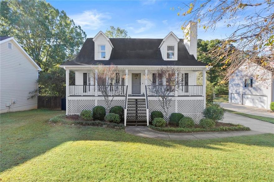 This home is an absolute DREAM! You're immediately greeted by a charming front porch, step inside to a gorgeous, light & bright, open floorplan--the living room is generously sized with a bay window and centered by a cozy fireplace and built in bookcases, and is open to a beautiful white kitchen with granite countertops, stainless steel appliances, and tons of storage, even a long peninsula perfect for hosting/entertaining.  Adorable banquette takes advantage of breakfast nook area with extra seating and tons of windows, and built in desk area makes for smart storage space.  Primary bedroom on main floor is generous in size with spacious en-suite bathroom including separate tub and shower, and walk in closet.  An additional powder room on the main floor as well as laundry conveniently located.  Upstairs, find 2 additional spacious bedrooms with dormer window nooks adding to the charm as well as a secondary bathroom.  Basement level offers additional living area/office/playroom/exercise space--whatever is needed!  And just wait til you see this fenced-in yard!  Recently built deck is a great extension of the living area and kitchen and overlooks a sprawling, over half acre flat yard with a fireplace at the back to soak up the outdoors!  All of this in the heart of Woodstock--super quick highway access, 5 minute drive to Target or Walmart, 10 minutes to downtown Woodstock, and tons of grocery stores right around the corner (including Aldi, Lidl, Kroger, Sprouts & more!)  It's everywhere you want to be, don't miss your chance to call it home!