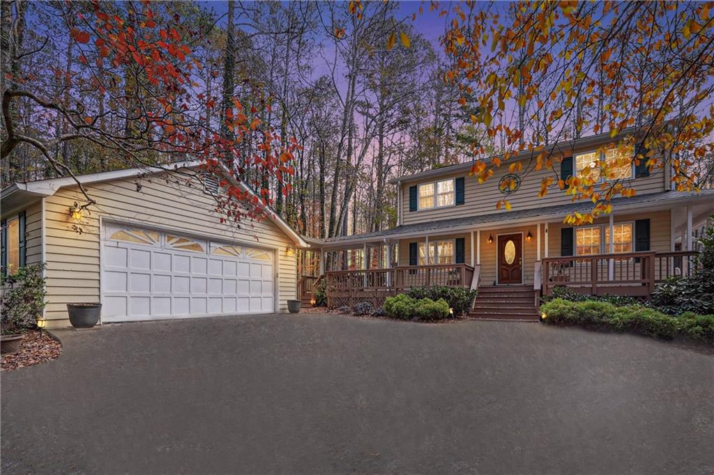 Rare 1.7-acre lakeside retreat in the heart of Marietta. Land value alone is worth asking price. Current updates include New Stove & Microwave (2021), Aquaguard Gutter System installed (March, 2024), New Shower & Sink in basement bathroom (March, 2024), Replaced Roof (2023) and New Garage Door Openers (December 2023). Home features a wrap-around porch, a screened sunroom, and a massive deck, all offering stunning views of the private lake. Inside, the spacious living room is centered around a cozy fireplace and flows seamlessly into the formal dining room. Gourmet kitchen boasts white countertops, cabinets, and a sunny breakfast nook. Primary suite offers a relaxing haven with an ensuite bathroom that includes a shower room and walk-in closet. Two additional bedrooms and a full bath are located on the upper level. Property also includes a detached two-bay garage, ideal for vehicles or extra storage. With its breathtaking lake views and modern amenities, this home offers the perfect combination of tranquility and convenience. Schedule your private showing today!