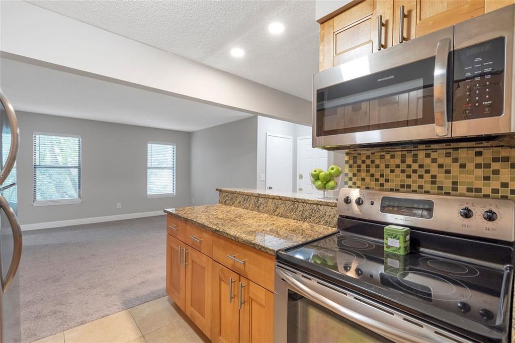 Welcome to your retreat in a swim and tennis community. Additional sunroom with a closet - perfect for a home office. Updated kitchen with stainless steel and granite countertops. New A/C and water heater. Freshly painted creates a bright and welcoming space. First level, with only 4 stairs from the street and the huge parking lot. Great for 1st Time Home-Buyers or Investors. No Rental Restrictions. Community features a swimming pool, tennis courts & pond, and HOA covers sewer/water/trash, termite, and exterior maintenance and landscaping. The Community is conveniently located close To GA 400 and 285 and near public transportation, shopping, schools and parks. Don't miss your chance, schedule a tour today!