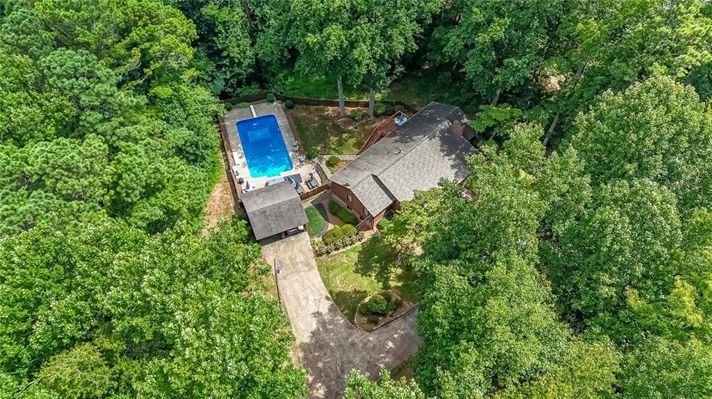Escape to your own private oasis in this stunning 3-bedroom, 3-bathroom ranch home nestled on a sprawling 2 acre lot. The home boasts a full daylight basement, partially finished to provide ample additional living space – perfect for a home theater, game room, or home office. Enjoy the ultimate tranquility; the house is discreetly set back from the street, approached via a long driveway leading to the home and a separate carport. Hosting large family gatherings will be a breeze with a the parking available.
The main level boasts a spacious, open-plan family room, complete with a cozy fireplace for those chilly evenings. Flowing seamlessly from the family room, the dining area opens onto a delightful deck, perfect for dining and entertaining. A sun-drenched sunroom, bathed in natural light from its expansive windows, provides a serene retreat where you can fully appreciate the beauty of your surroundings. The perfect reading spot or room for game night with the family.
The master suite, conveniently located on the main level, offers a luxurious, updated, handicap-accessible shower with elegant ceramic tile and glass doors. Two generously sized secondary bedrooms, also on the main level, share a full bathroom, providing ample space for family and guests.
The true heart of this property is its spectacular oversized in-ground pool, a shimmering centerpiece for unforgettable summer days and evenings. The accompanying pool house is cleverly designed with functionality and relaxation in mind. One section securely houses the pool equipment, while the other creates a charming covered patio—the perfect spot for al fresco dining, casual gatherings, or simply unwinding with a cool drink. Picture yourself hosting unforgettable barbeques, poolside birthday parties, or simply enjoying quiet evenings under the stars.
Mature trees surround the property, providing natural shade and enhancing the sense of seclusion. The ample parking ensures that entertaining large groups is effortless and enjoyable. This is more than just a home; it's an opportunity to cultivate a life filled with tranquility, relaxation, and cherished memories.
The perfect house, the perfect setting, and the perfect location!!