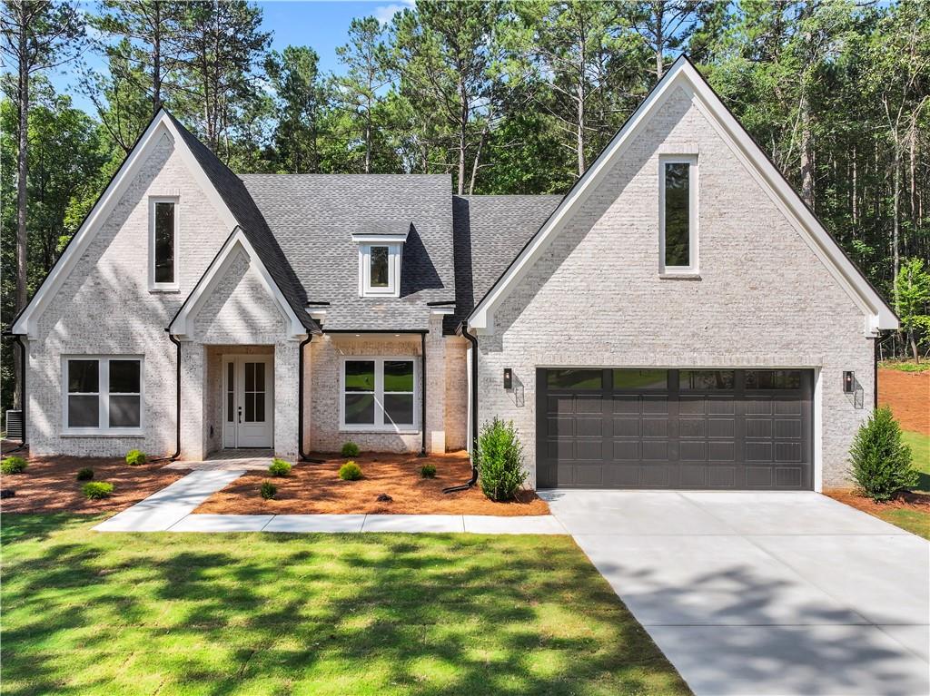Welcome to your modern day cottage! This beautifually crafted new construction offers a varitey of modern finishes combined with a cozy character. Settled on a 1.10 acre lot tucked into a cul-de-sac, your modern cottage provides the luxury of a secluded space in an already peaceful neighborhood with no HOA. As you make your way to the entrance of the home you are greeted with a beautiful herringbone brick design. With lots of living space you will find every room to have 10ft high ceilings with the exceptions of the 12ft high foyer and study, 14ft high dining room, and an 18ft high vaulted ceiling in your great room. This is a 3 bed, 2 1/2 bath with a beautiful luxe poreclain tile in both of your full baths. To name a few honorable mentions in your dreamy cottage includes a grand walk in pantry, a walk in closet with built in shelving, spray foam insulation throughout the entirety of the home, herringbone kitchen backsplash, a nicely crafted dry bar, and a covered rear porch adorned with tounge and groove ceilings.