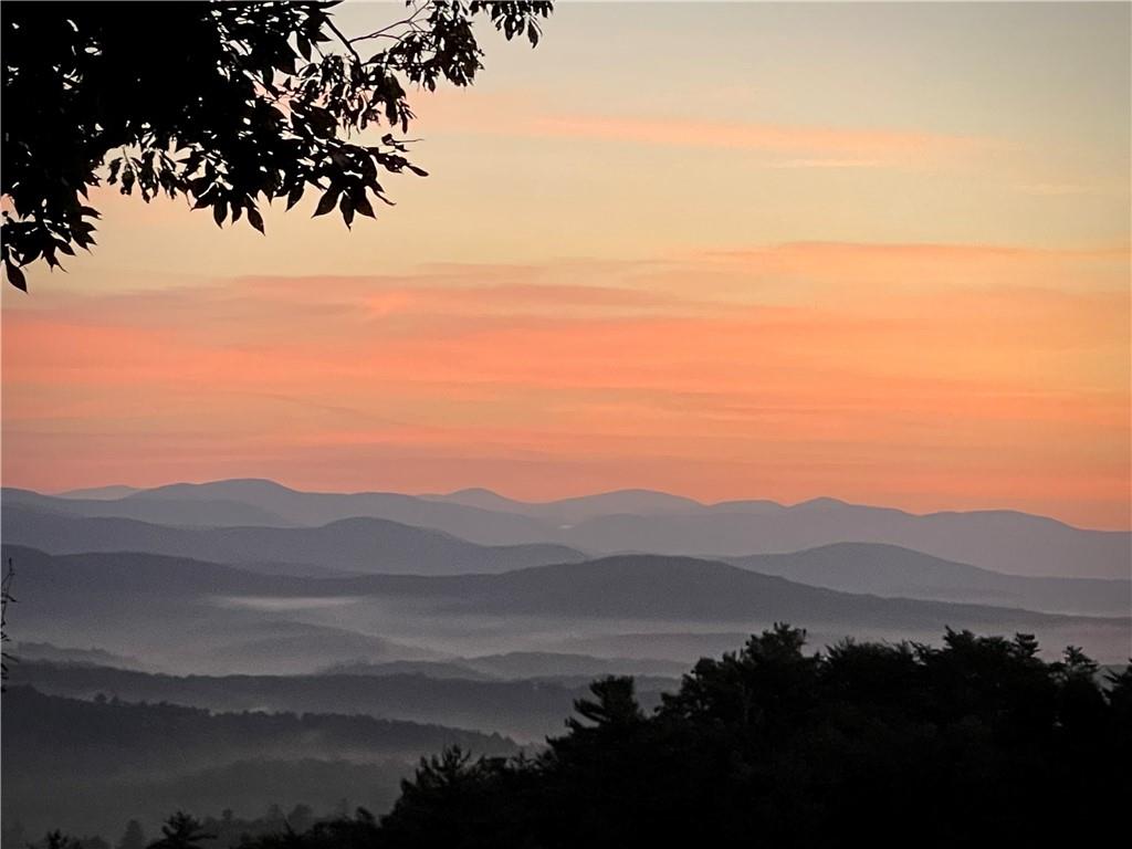 If you are looking for a lot with beautiful with long-range mountain views this 3.28 acre lot offers fabulous views of Amicalola Falls the tallest falls east of the Mississippi. You will also have the sound of a mountain stream that runs along the side of the lot. The lot is protected by community green space on two sides, offering a private location for your new home. A site survey with a proposed home to be built is available, and the BC AECD department has already approved this plan, making the building process much easier. Overall, this lot is a great opportunity for someone looking to build their dream home on a high-end street in the beautiful community of Big Canoe.