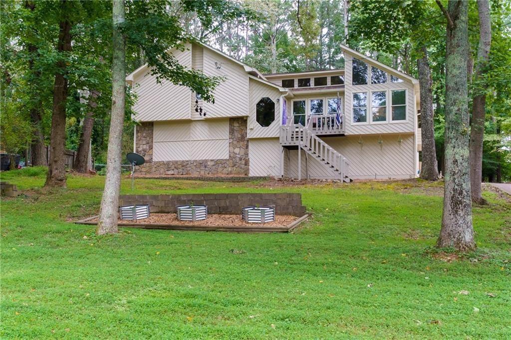 Welcome Home to 314 Bethel Drive Where Comfort Meets Community! Tucked away in a friendly swim/tennis neighborhood, this charming Woodstock home offers the perfect mix of space, warmth, and convenience. Just a short drive/golf cart drive to Lake Allatoona, Sunset Grille, Victoria Marina, JD’s on the Lake, and Little River Marina—you’ll love being so close to the water, dining, and fun! Step inside to an open, airy floor plan with a vaulted family room that feels bright and welcoming. The updated kitchen flows right into the dining room, making it easy to gather with family and friends. With 4 spacious bedrooms and 3 full bathrooms, there’s room for everyone to feel right at home. Outside, the multi-level back deck is perfect for summer cookouts or quiet mornings with coffee. The fenced backyard gives you privacy and plenty of space to play, garden, or just relax. There’s even a workshop and a bar area in the garage—ideal for weekend projects or hosting game day. From the friendly neighbors to the unbeatable Woodstock location, 314 Bethel Drive is more than just a house—it’s a place to call home.