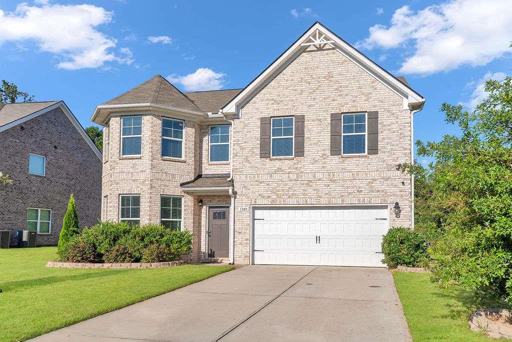 ***Luxury Living in Locust Grove's Most Sought-After Community - Berkley Lakes *** Discover timeless elegance and modern comfort in this stunning 5-bedroom, 3-bath residence nestled in the highly desirable Berkley Lakes community. Perfectly designed for both everyday living and entertaining, this home offers an open-concept layout filled with sophisticated details and thoughtful spaces. The main level welcomes you with soaring ceilings, gleaming hardwood floors, and a seamless flow from the formal dining room with coffered ceilings to the inviting living and gathering areas. The chef's kitchen is a showpiece, featuring crisp white cabinetry, stainless steel appliances, granite countertops, and a sunny breakfast area overlooking the family room. Step outside to enjoy peaceful mornings or intimate gatherings on the private patio. A versatile main-level bedroom with a full bath offers the perfect retreat for guests, loved ones, or flexible use as a home office or gym. Upstairs, a spacious loft provides the ideal second-level entertainment space. The luxurious primary suite is a true retreat, complete with an expansive sitting area and a spa-inspired bath boasting a soaking tub, separate shower, and dual vanities. Three additional bedrooms and a full bath offer plenty of space for loved ones and guests alike. The exterior is just as impressive, with a large backyard designed for entertaining and relaxation, backing up to the community walking trail for serene morning or evening strolls. Enjoy the best of Locust Grove living with close proximity to the Shoppes and dining of Locust Grove, Tanger Outlets, and easy access to Interstate 75. This Berkley Lakes gem blends elegance, space, and convenience-an exceptional opportunity to call one of Locust Grove's premier communities home. Schedule your private tour today.