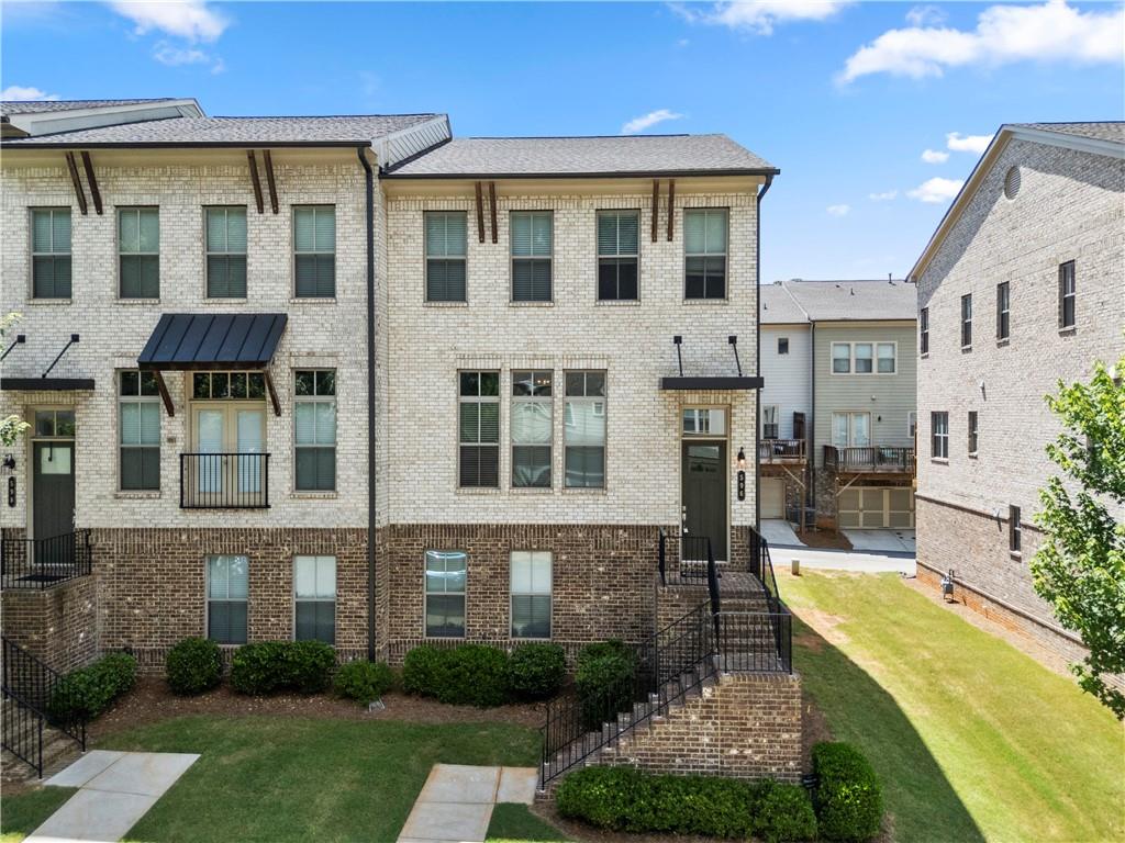 One of the largest floor plan featured four-bedroom three full bath end-unit townhome located in the highly sought-after Avondale Hills community. Freshly painted whole and garage. 10-foot ceilings on the main level and hardwood floors throughout, No Carpet. Enjoy a chef-style kitchen with generous island, and a walk-in pantry for effortless organization and an open-concept layout that flows into the dining area and onto the private deck. Expansive living room with oversized windows, streaming sunlight, and a charming gas fireplace as the focal point, pre-wired and ready for your TV setup. Upstairs, the bright primary suite offers a double vanity bathroom, large shower, and a walk-in closet. Two additional bedrooms, a full bath, and a spacious laundry room complete this level. Private bedroom suite located on the first level, includes another massive walk-in closet, and private full bath. This home is located just outside Historic Avondale Estates, only a couple of miles from Downtown Decatur, and a short drive to the Atlanta Beltline, Midtown, and Downtown Atlanta. Enjoy nearby shopping, restaurants, Publix, Your DeKalb Farmer's Market, and Marta is within walking distance.