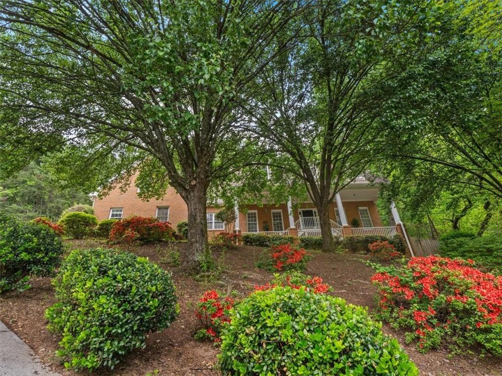 Reduced! Updated home in one of Cobb County's most sought after school districts. This home has 4 bedrooms, 3.5 baths and a spacious bonus room. Amazing views, private but close to everything, including shopping and hiking trails. Main level includes a formal living room, large dining room, family room with a fire place, eat-in kitchen, and a laundry room. Also on the main level, is a large bedroom with an updated bathroom. The second level has a spacious master bedroom with a walk-in closet and a renovated ensuite bathroom. There is also a bonus room with a half bath that could be used as a playroom, an office, or another bedroom. Professionally landscaped backyard with a large deck.