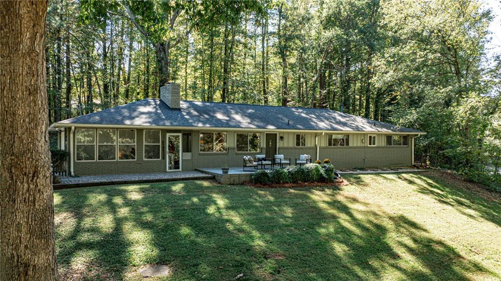 Welcome home to 433 Kelly Drive — a beautifully loved 4-bedroom, 2-bath retreat that perfectly blends charm, comfort, and nature. Tucked away among the trees, this home offers peaceful wooded views from every window, giving you the sense of being worlds away while still just minutes from everything. The inviting floorplan features bright, open living spaces and a gorgeous sunroom that brings the outdoors in — the perfect spot for morning coffee or cozy evenings surrounded by nature. The kitchen flows easily into the dining and living areas, making entertaining effortless. Step outside to enjoy a private patio overlooking mature trees and open skies for sunrise and sunset views. Each bedroom offers warmth and comfort, and the home has been well cared for throughout. Located beside a picturesque horse farm, this property captures a rare mix of privacy, beauty, and connection to nature. A truly special home ready for its next chapter!
