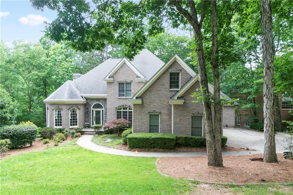 At almost 7200 square feet, this is a home you will not want to miss with over $45,000 new renovations. Fantastic 3 sides brick home with 3 car garage located on a private flat lake front lot in the established Nesbit Lakes community. Features master on main with oversized master bath as well as separate living and dining room areas. Chef's kitchen with a huge island overlooking the open floor plan family room. 4 large bedrooms located upstairs - 1 bedroom is ideal for an office, library, playroom, or media room. Fully finished basement featuring additional family room, game room, exercise room, office, and full bedroom and bathroom - perfect for in-law suite with newly completed hardwood floor and storage room. All bathrooms just had newly installed screen shower doors. Beautiful chandelier light was installed in the front doorway. Huge screened porch overlooking a private lake lot where you can fish. No detail has been overlooked in this home. Active swim and tennis community with access to lake, perfect for kayaking and fishing. Active neighborhood amenities include clubhouse, six tennis courts, swimming pool, splash park, playground, and 2 firepits. Walking distance to Centennial High School and Mount Pisgah Christian School.