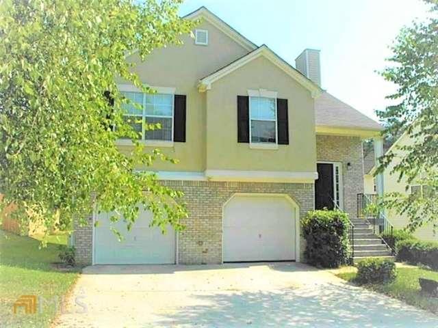 The home offers an open floor plan with high ceilings in the living area, has upgraded interior flooring, and has been freshly painted throughout. The kitchen features beautiful, solid countertops and stainless appliances. Oversized primary suite has solid countertops, soaker tub with a separate shower. Note: 3 bedrooms close by and a 1-bedroom suite on the lower level with a large den; move-in condition. Roomy garage; extra-deep 2-car garage on the lower level lot. Great Cobb County school district, very close to shopping and recreation. No pets... Well, sought-after neighborhood. Easy access to I-75, the Battery/Braves Stadium, the Silver Comet Trail, and Marietta Square.